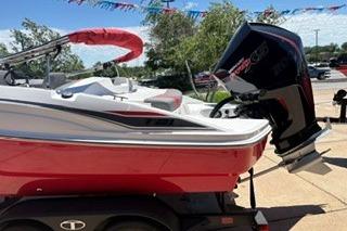 2026 Tahoe T21 boat with red hull and powerful outboard motor on trailer.