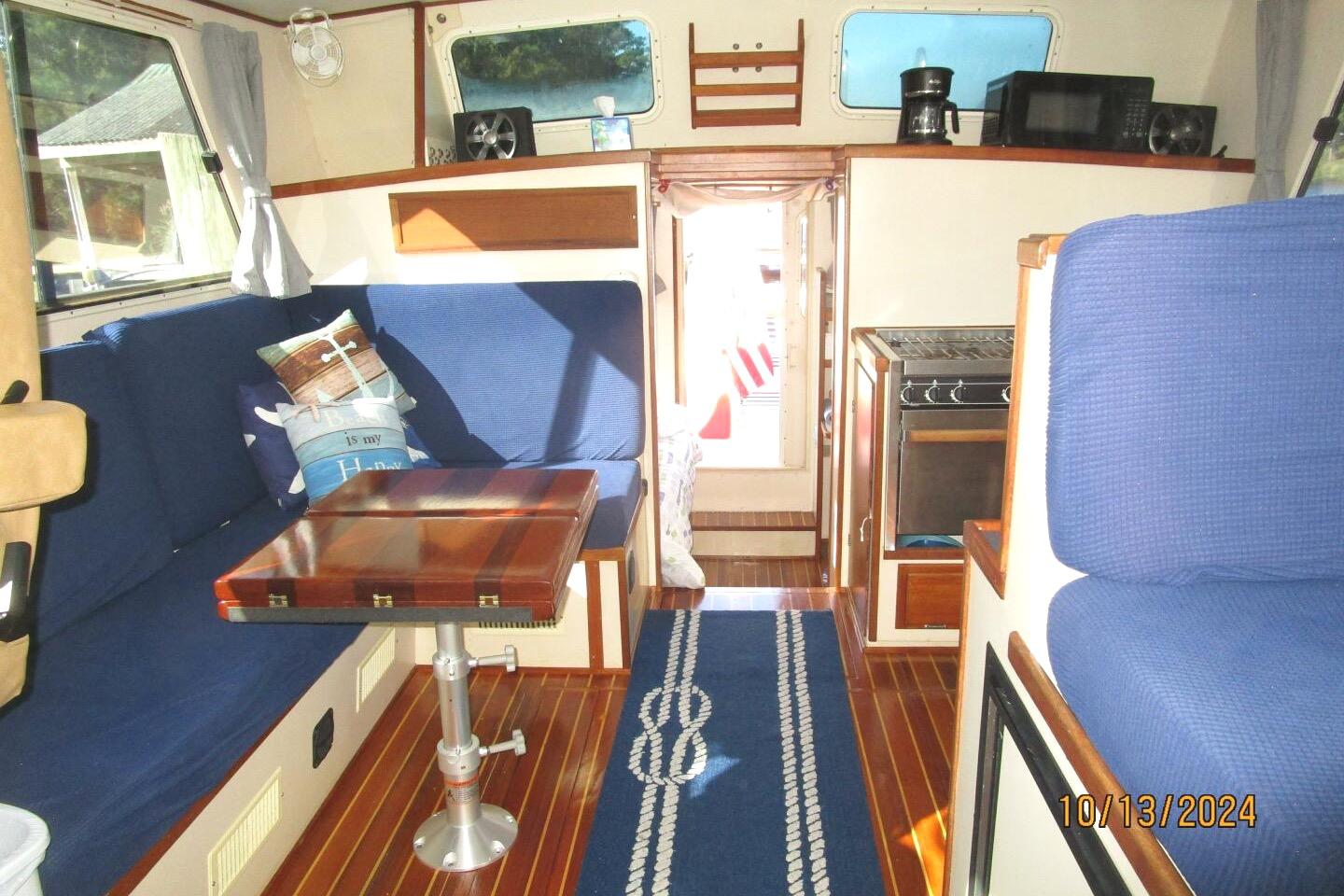 Interior of a 1997 Rosborough Trawler with blue seating and wooden accents.