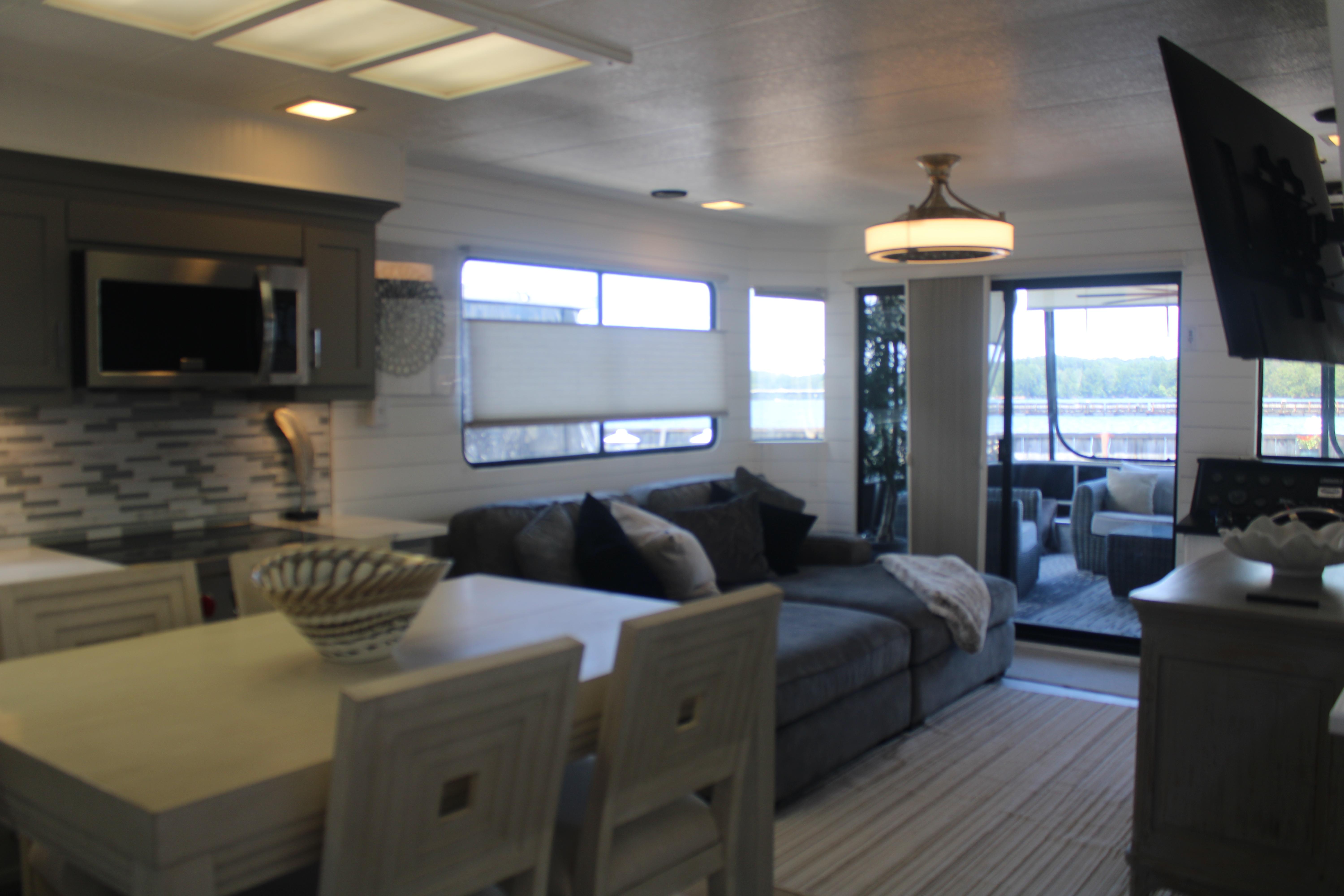 Interior of a 1992 Sumerset 66 houseboat with modern kitchen and cozy living area.