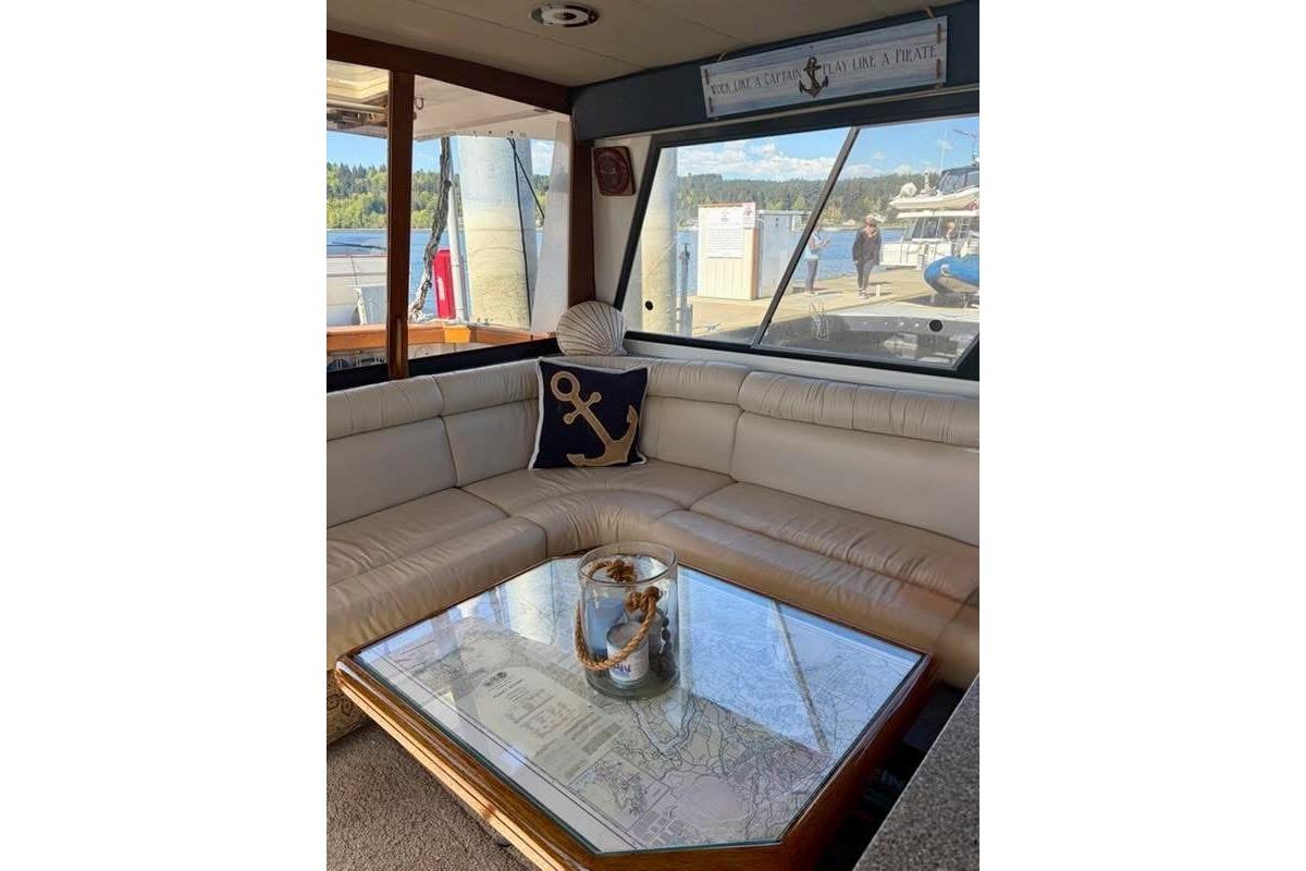 Interior of 1993 Bayliner 4588 Pilothouse with nautical decor and waterfront view.