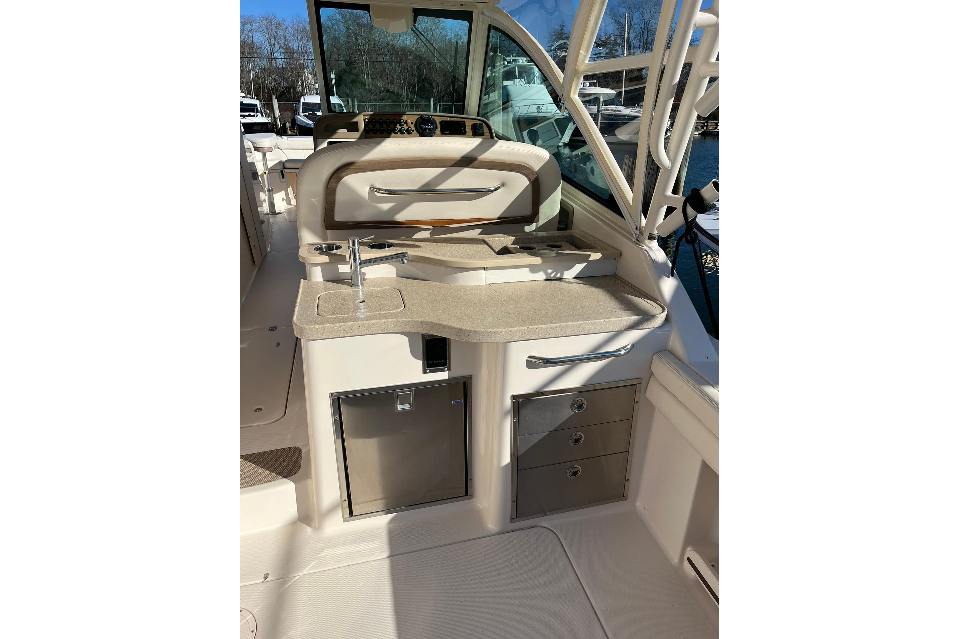 2015 Grady-White Freedom 375 boat interior with sink and storage drawers.