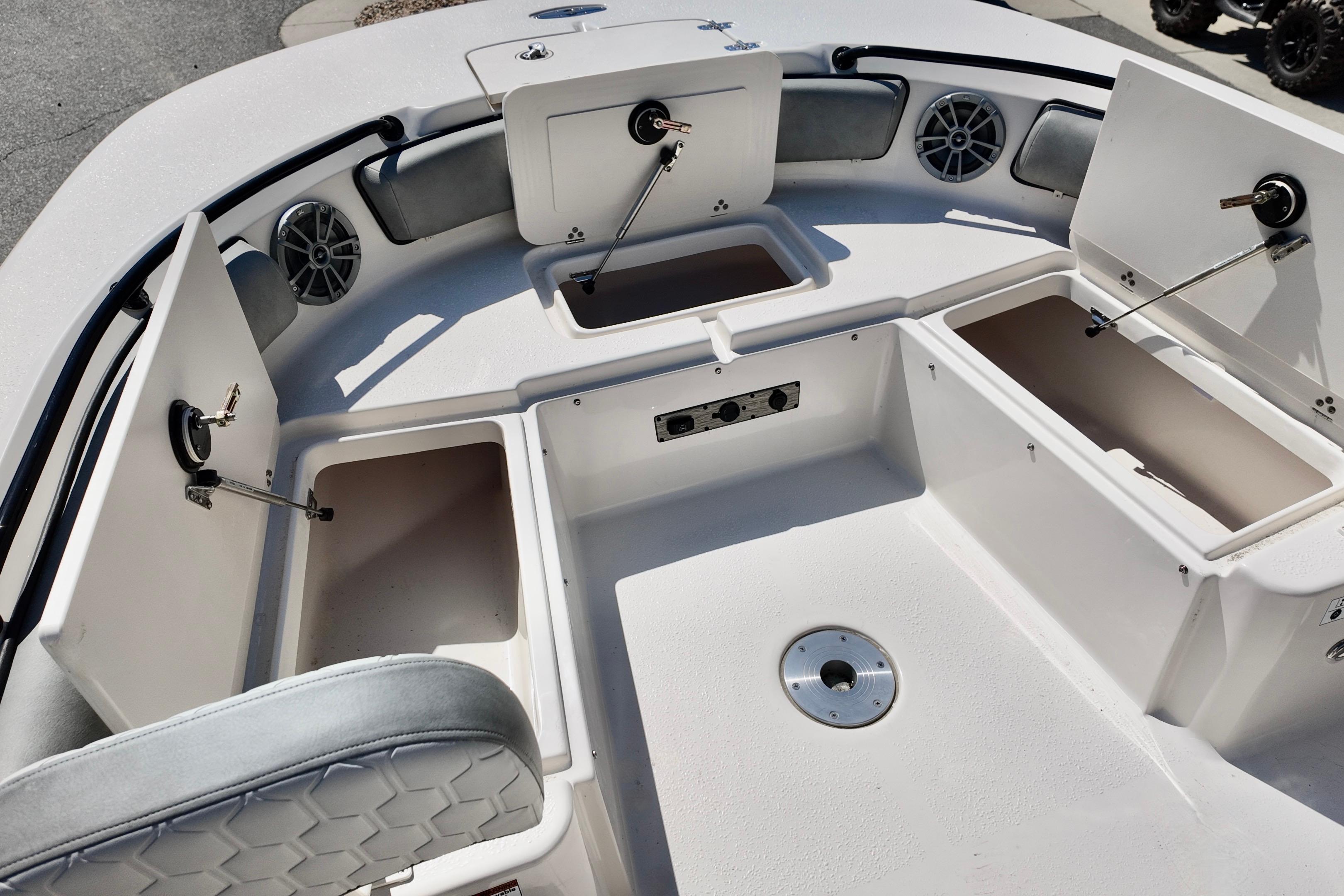 2026 Carolina Skiff 21 Ultra Elite boat interior with open storage compartments and speakers.