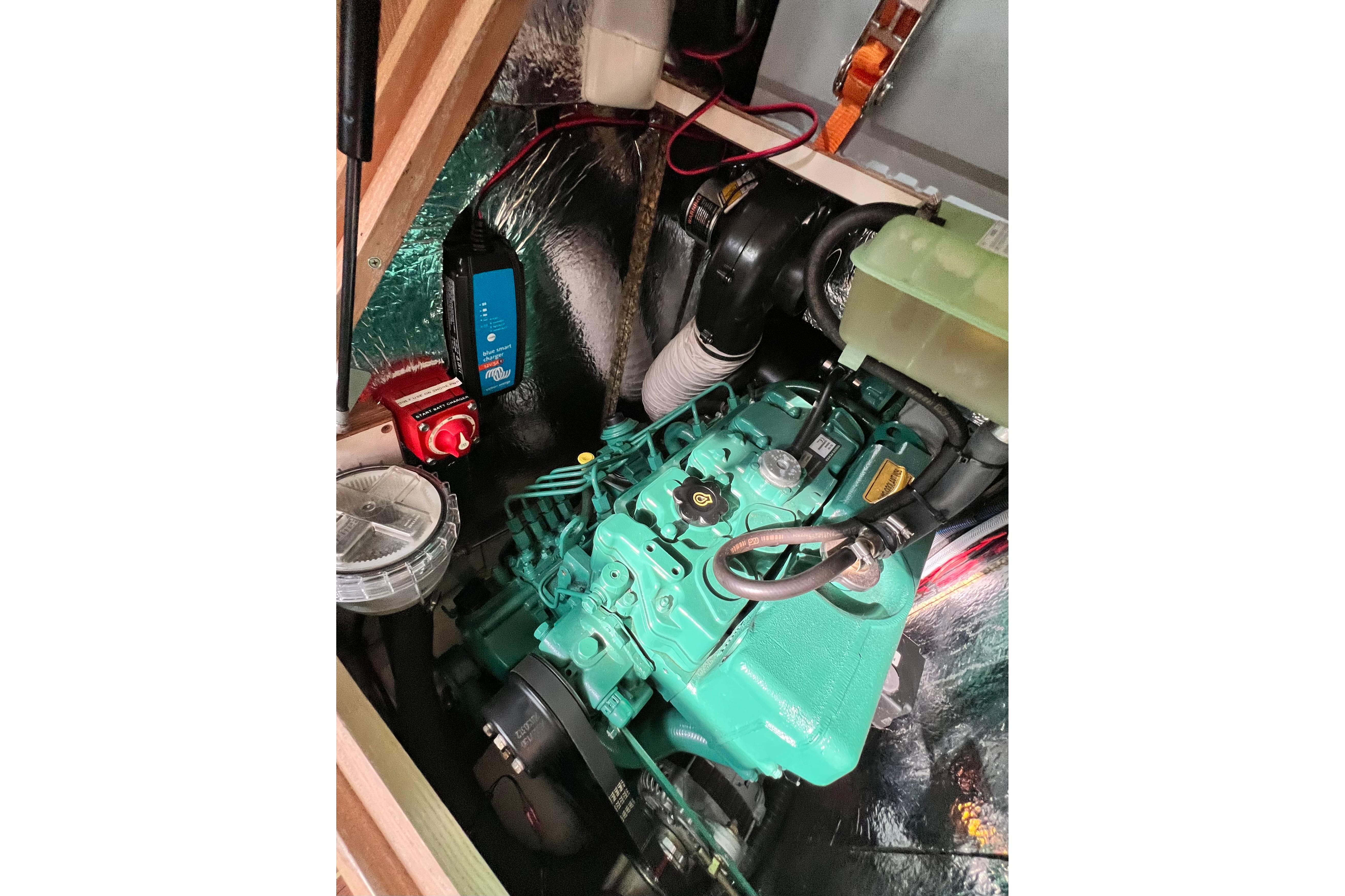 Engine compartment of a 2016 Hanse 455 yacht, featuring a green marine engine.