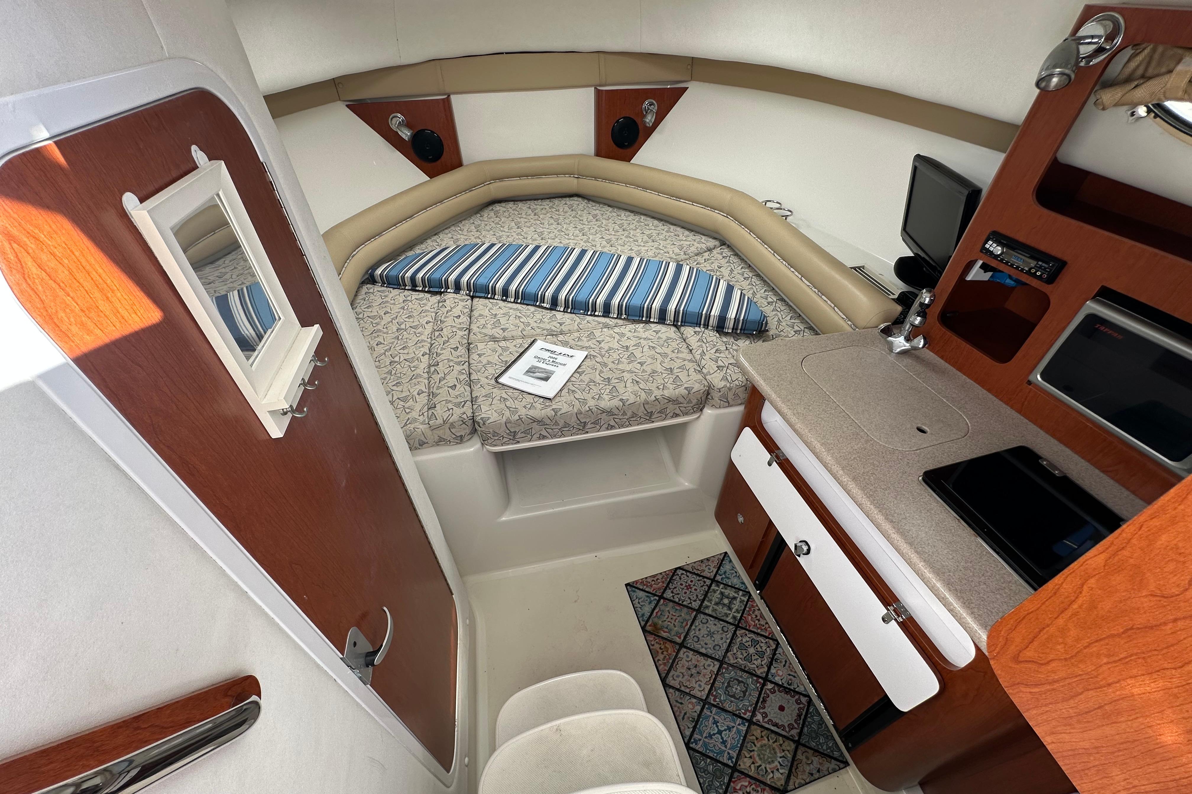 Interior of 2006 Pro-Line 32 Express boat with cozy cabin and compact amenities.