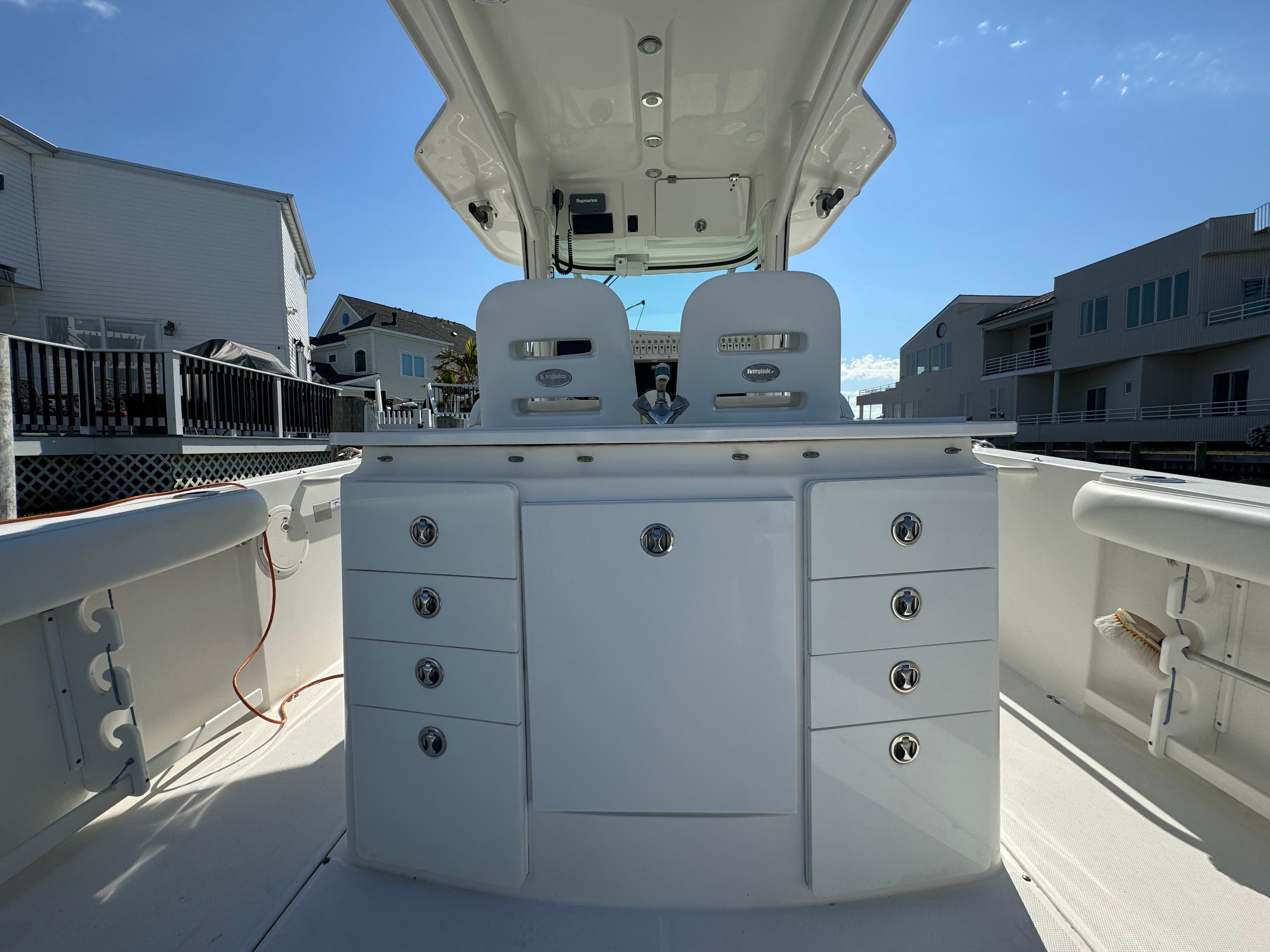 2011 Everglades 325 Center Console boat interior with storage compartments and seating.