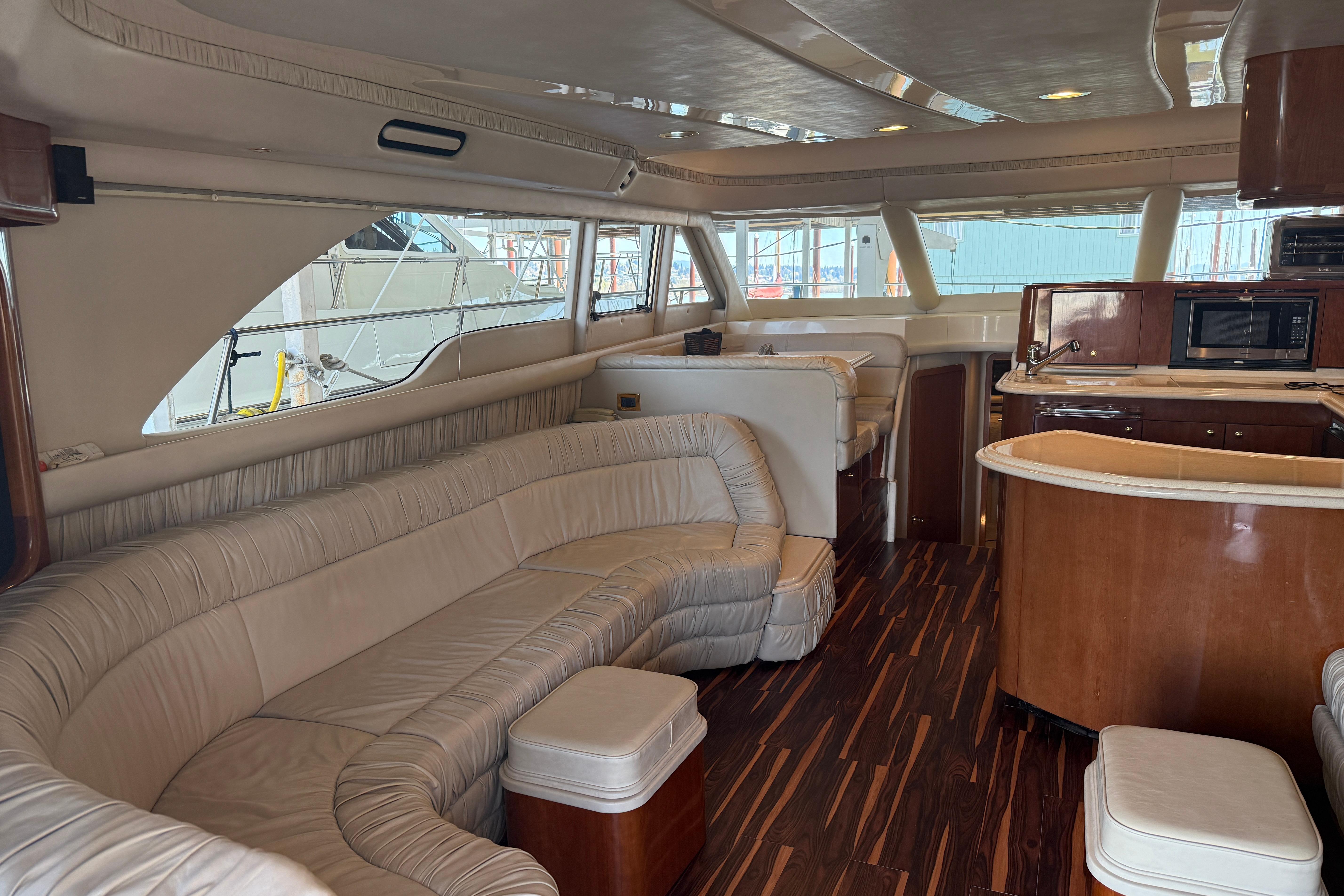 Luxurious interior of a 1999 Sea Ray 560 Sedan Bridge yacht with elegant seating and wood finishes.