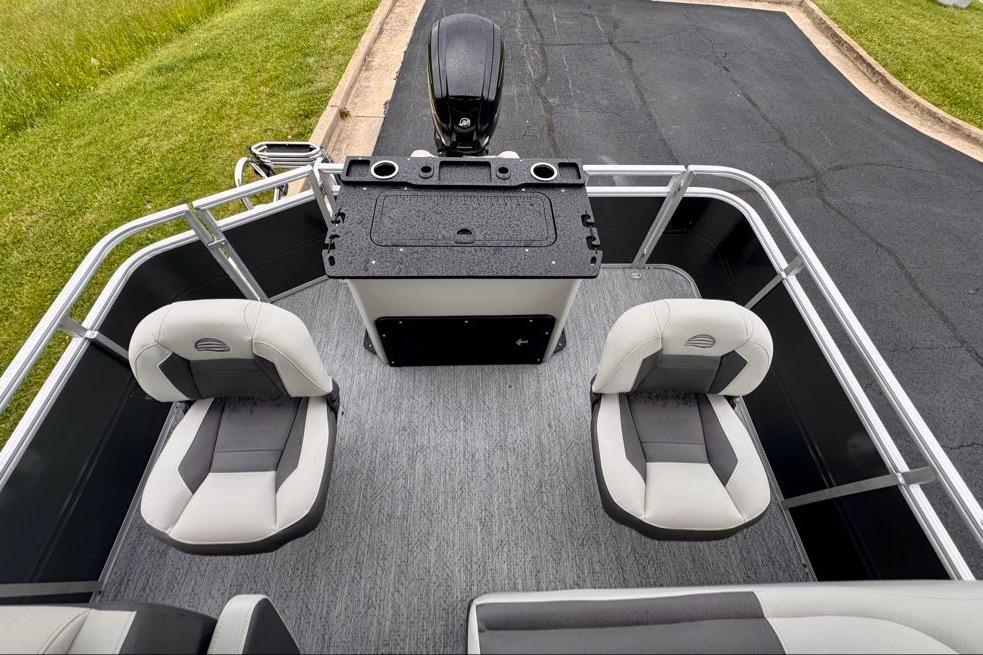 2026 Sun Tracker Fishin' Barge 20 DLX interior with seating and control console.