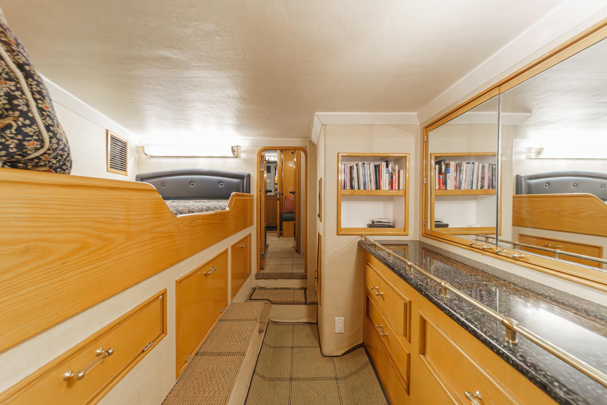 Luxurious interior of a 1990 Seaton Long Range Cruiser with wood cabinetry and mirrored surfaces.