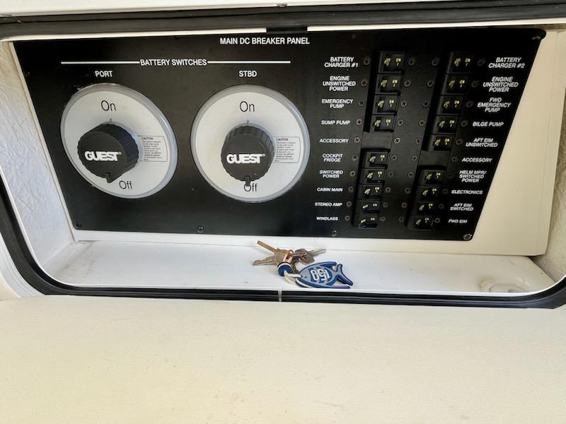 Main DC breaker panel on 2012 Sea Ray 330 Sundancer with keys placed on it.