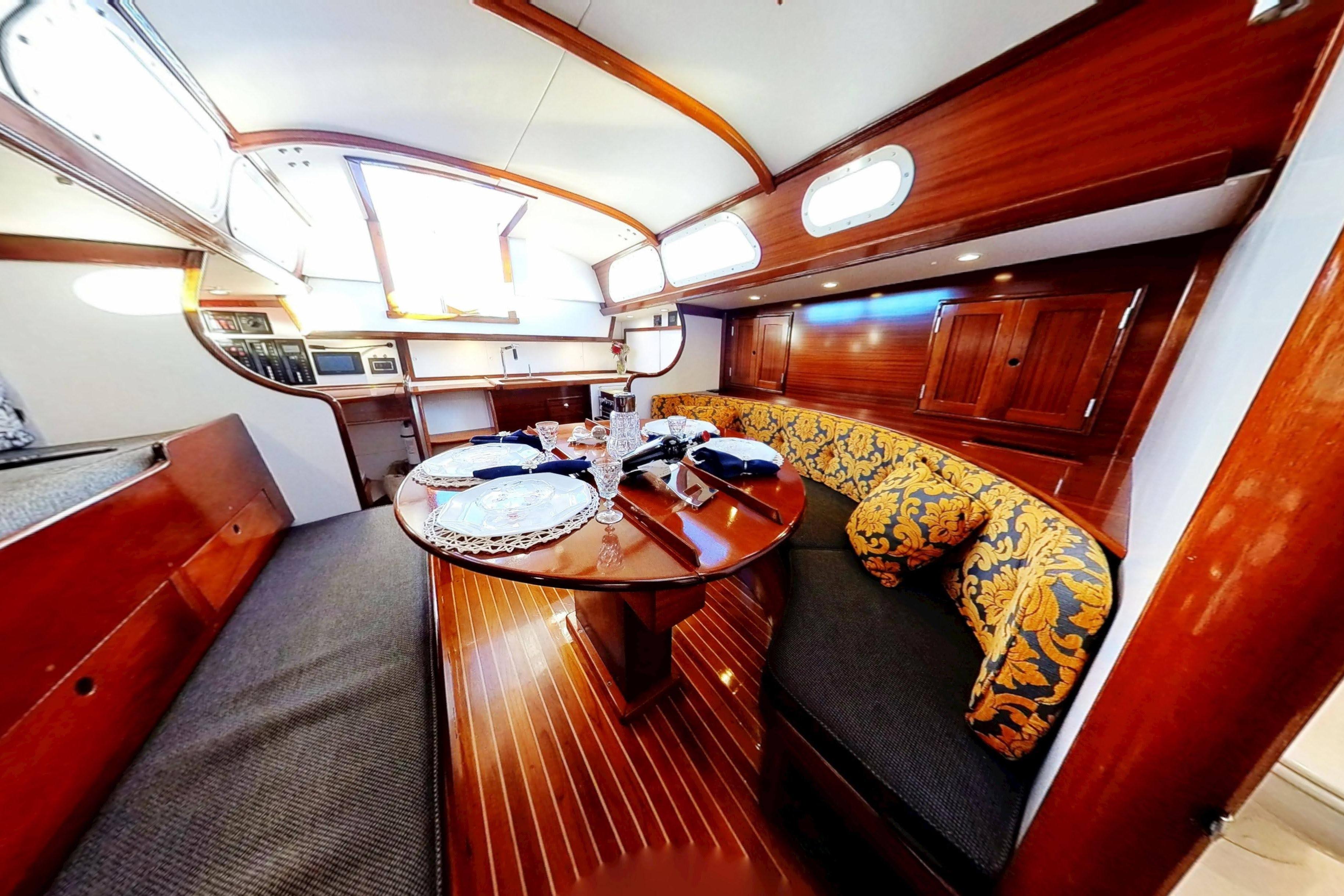 Interior of a 1970 Hinckley Bermuda 40 yacht with elegant wood finish and cozy seating.