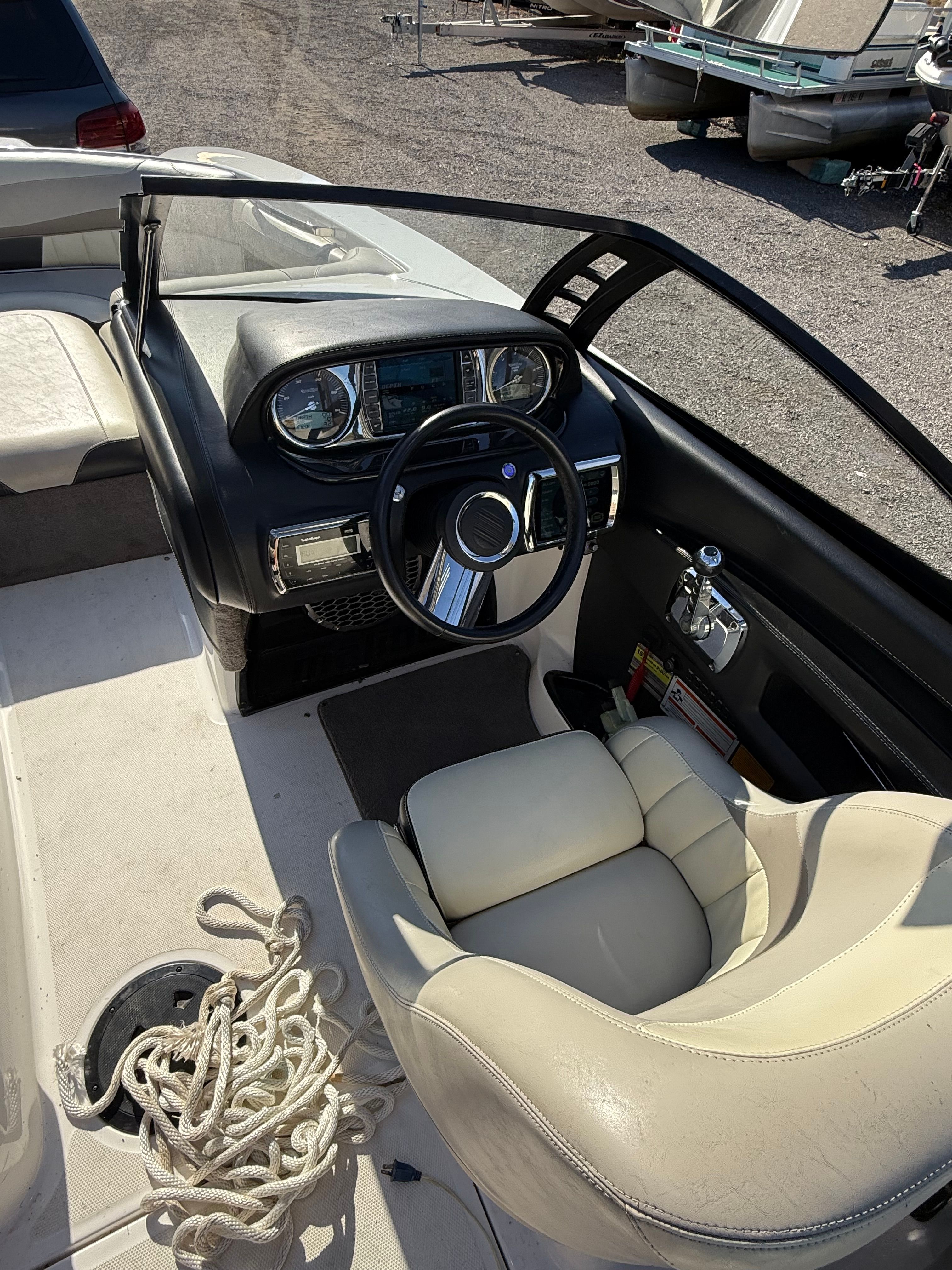 The image shows the cockpit of a 2013 Malibu Wakesetter 22 MXZ with a sleek steering wheel.