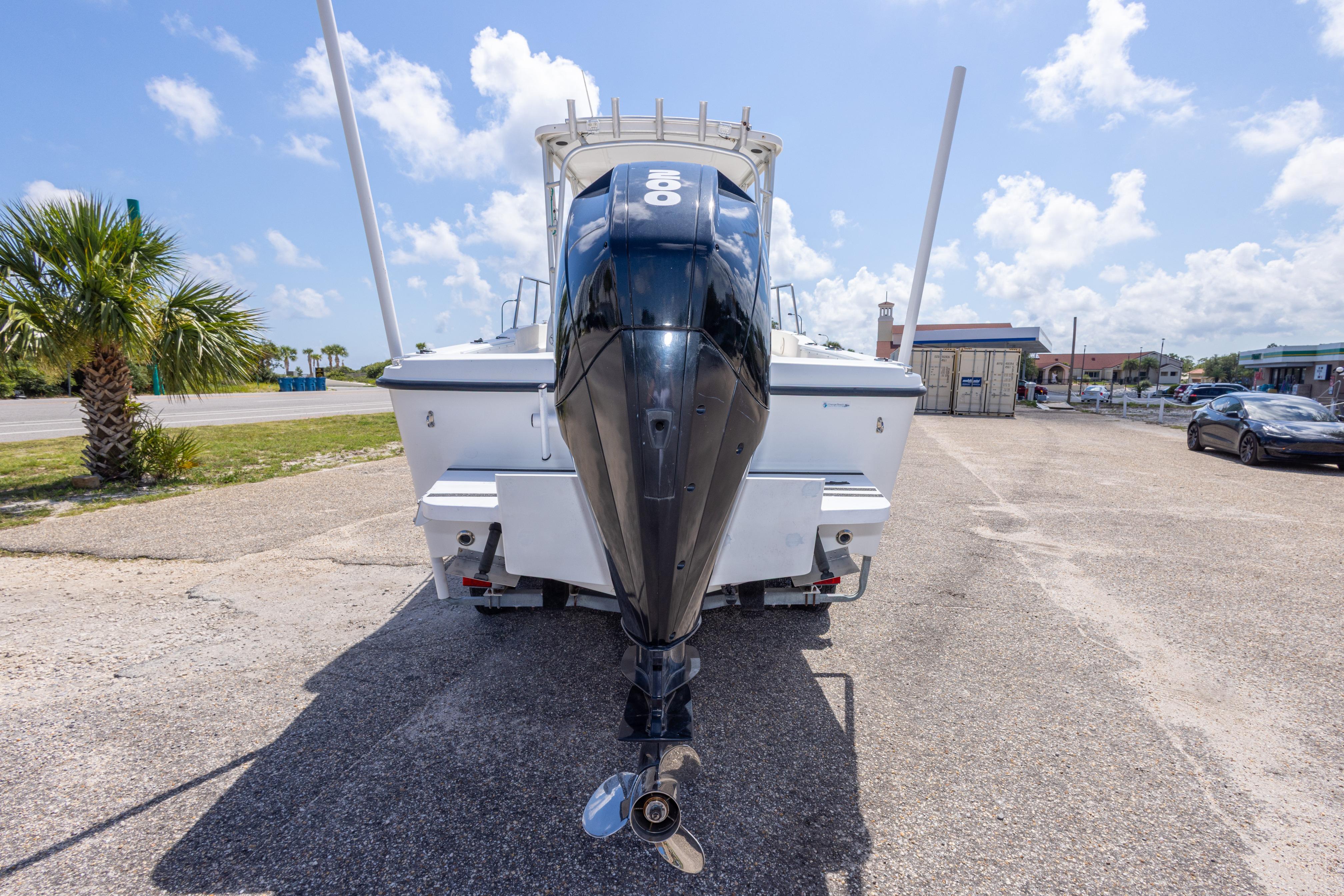2007 Sea Boss 235 Walkaround boat with outboard motor, parked on a sunny day.