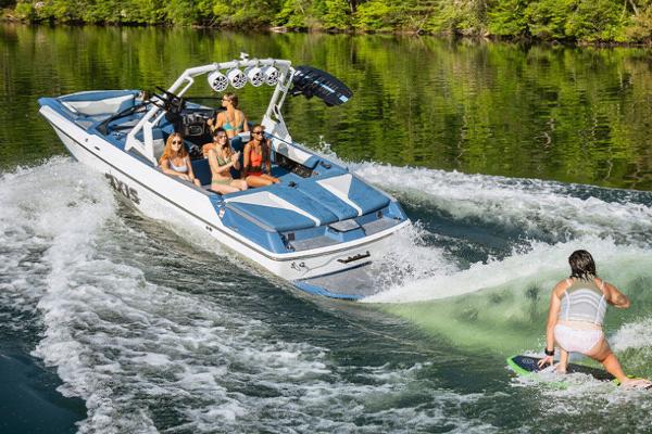 Manufacturer Provided Image: 2022 Axis A22 boat towing a wakeboarder on a lake.