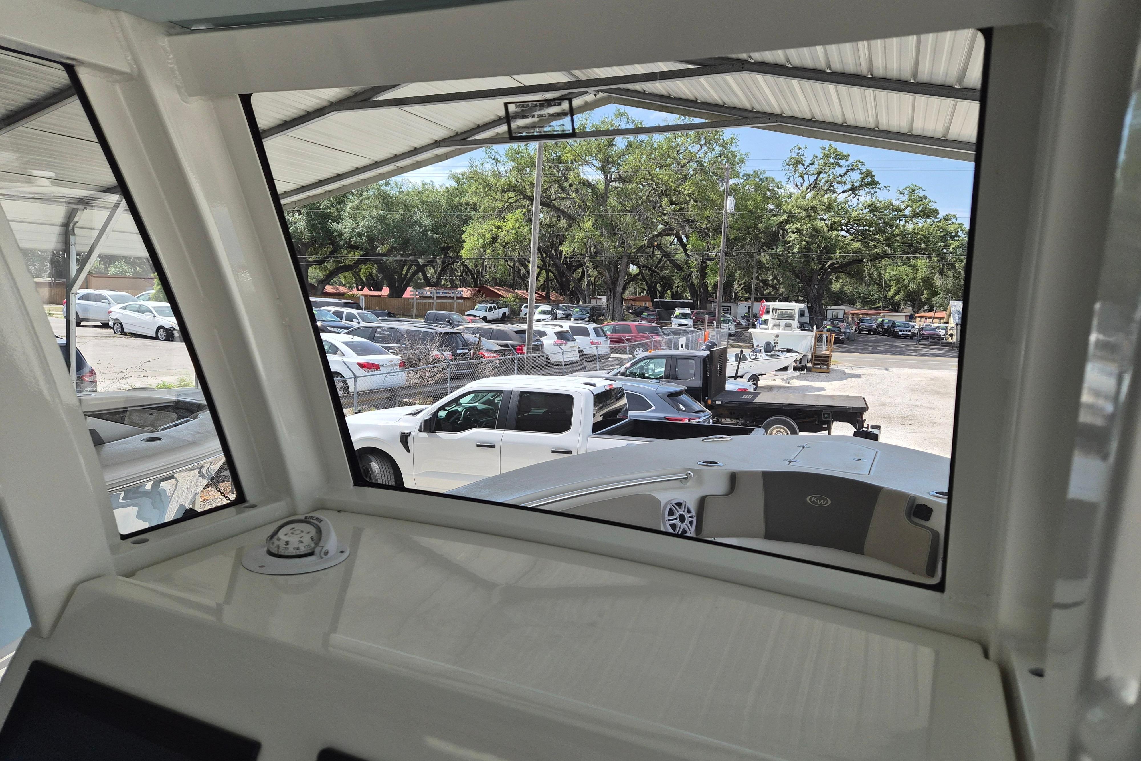 Interior view from 2026 Key West 260 Center Console boat, overlooking parking lot.