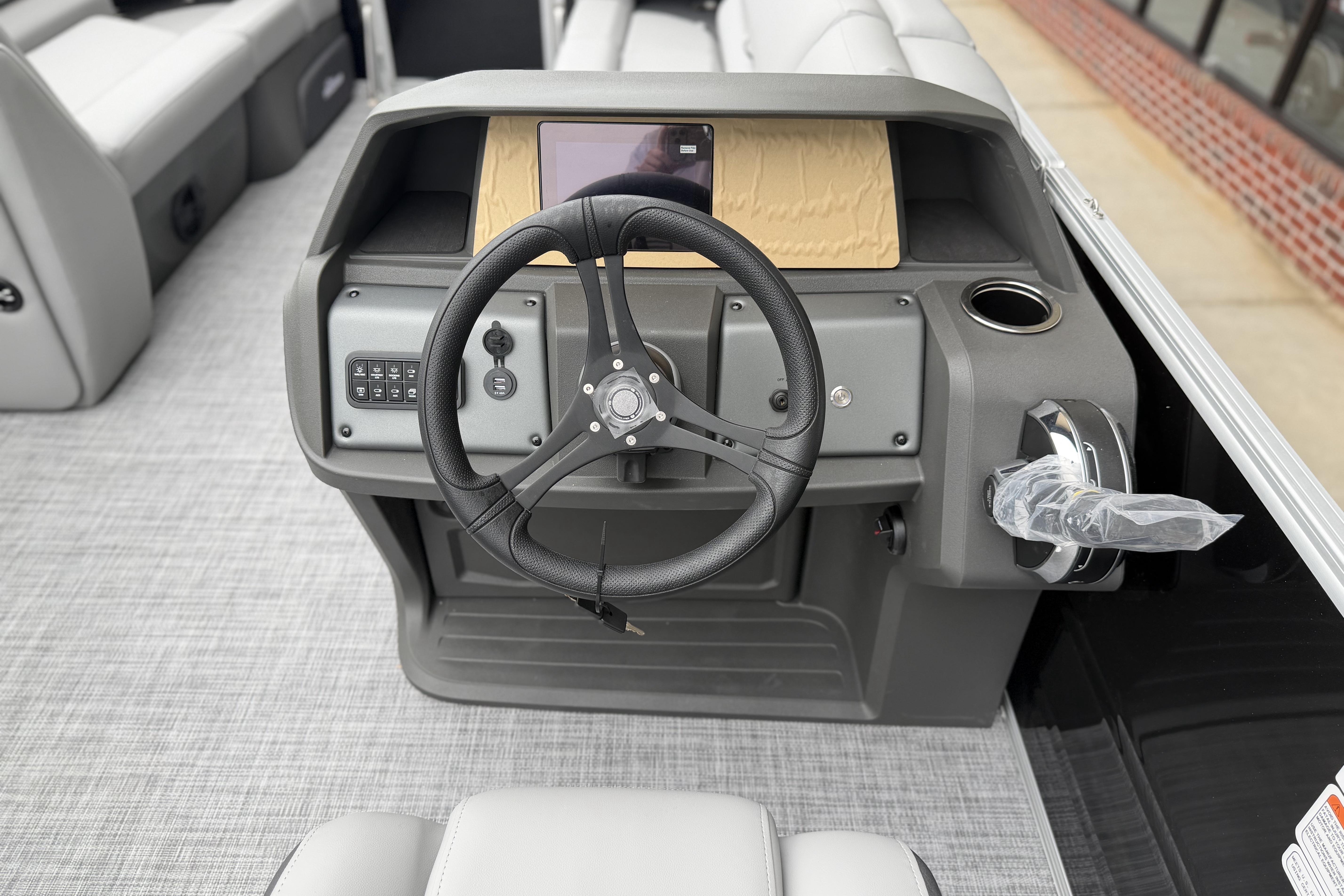 2026 Sun Tracker Party Barge 20 DLX steering console with modern controls and sleek design.