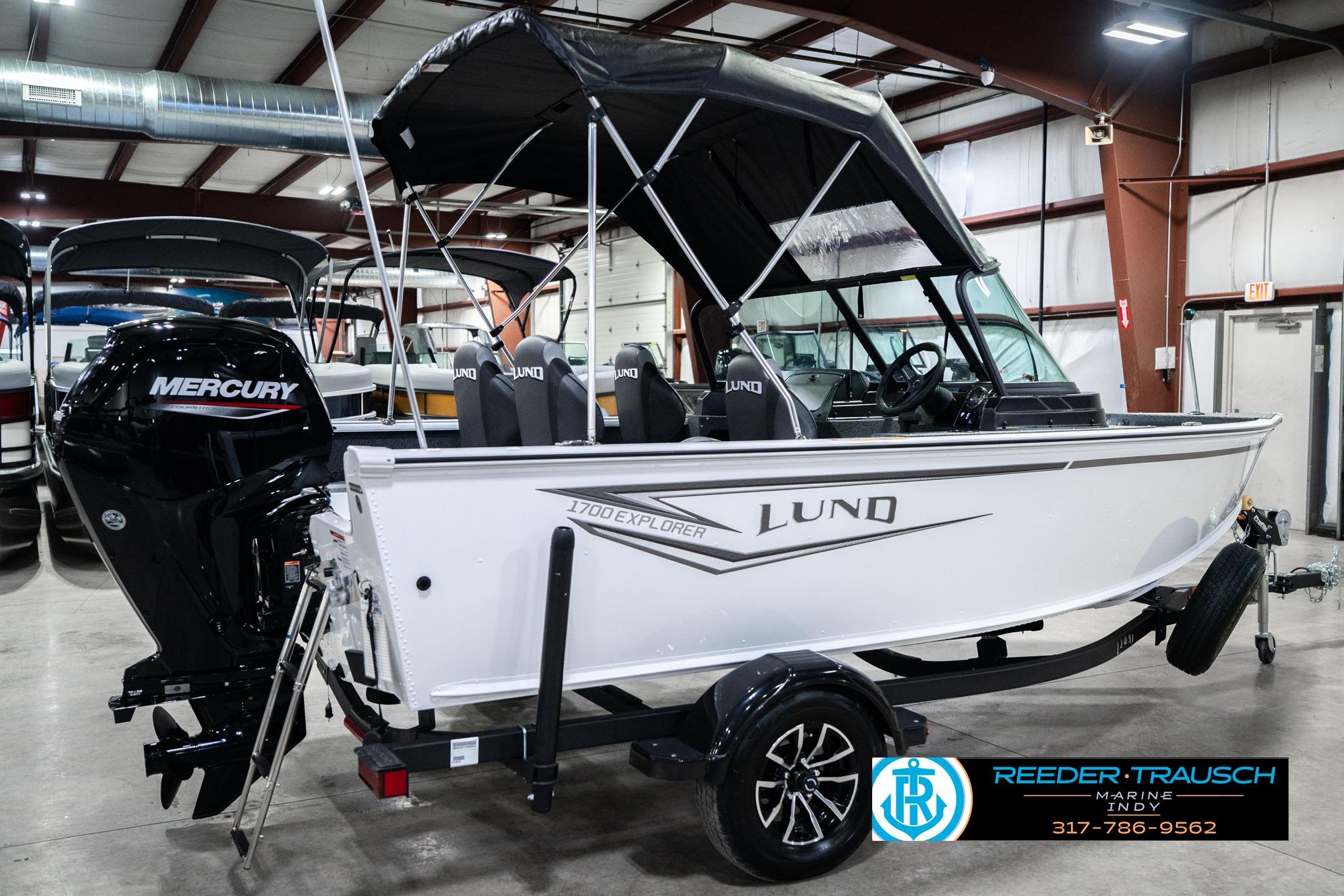 2026 Lund 1700 Explorer Sport boat with Mercury engine in showroom.