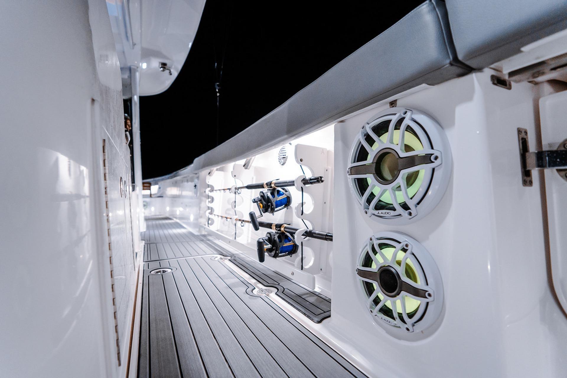 Interior view of 2026 Everglades 455 Center Console boat with fishing rods and speakers.