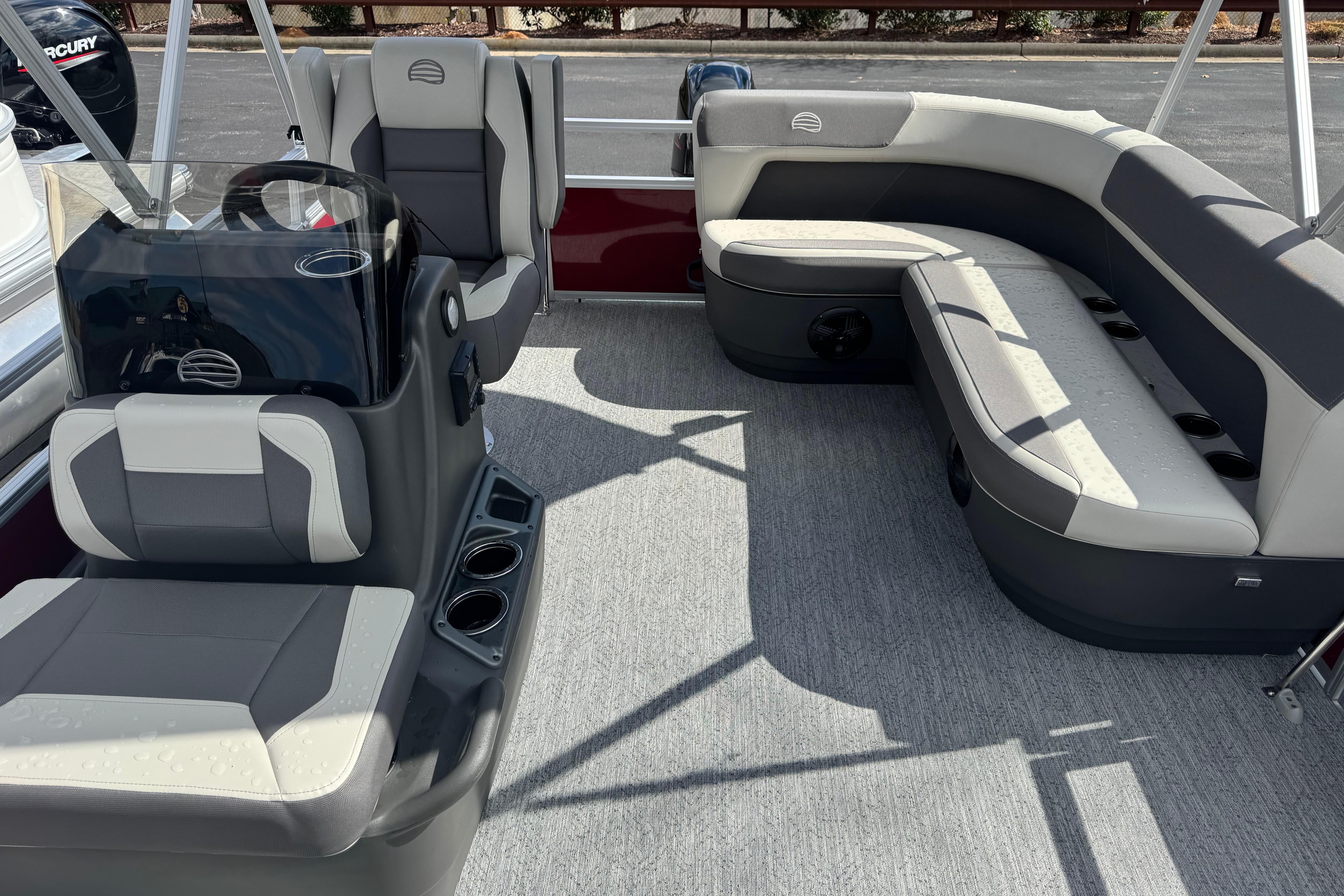 2026 Sun Tracker Bass Buggy 16 XL Select pontoon boat interior with gray seating and steering console.