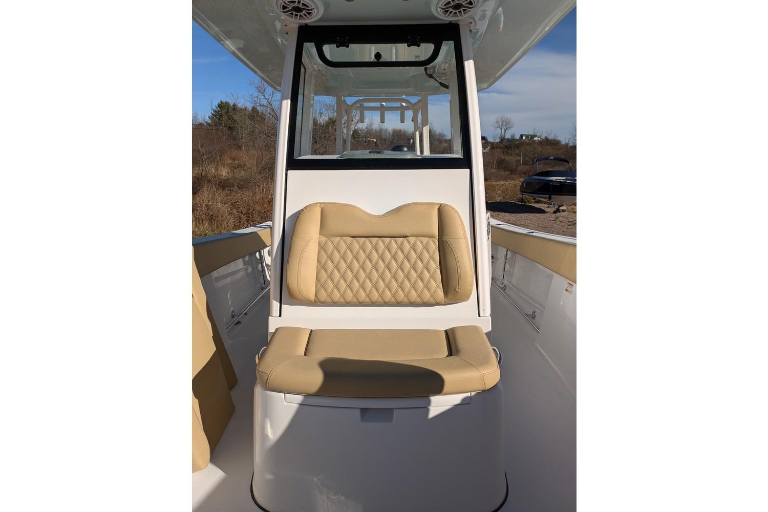 2025 Sportsman Open 282 Center Console boat with tan cushioned seating.