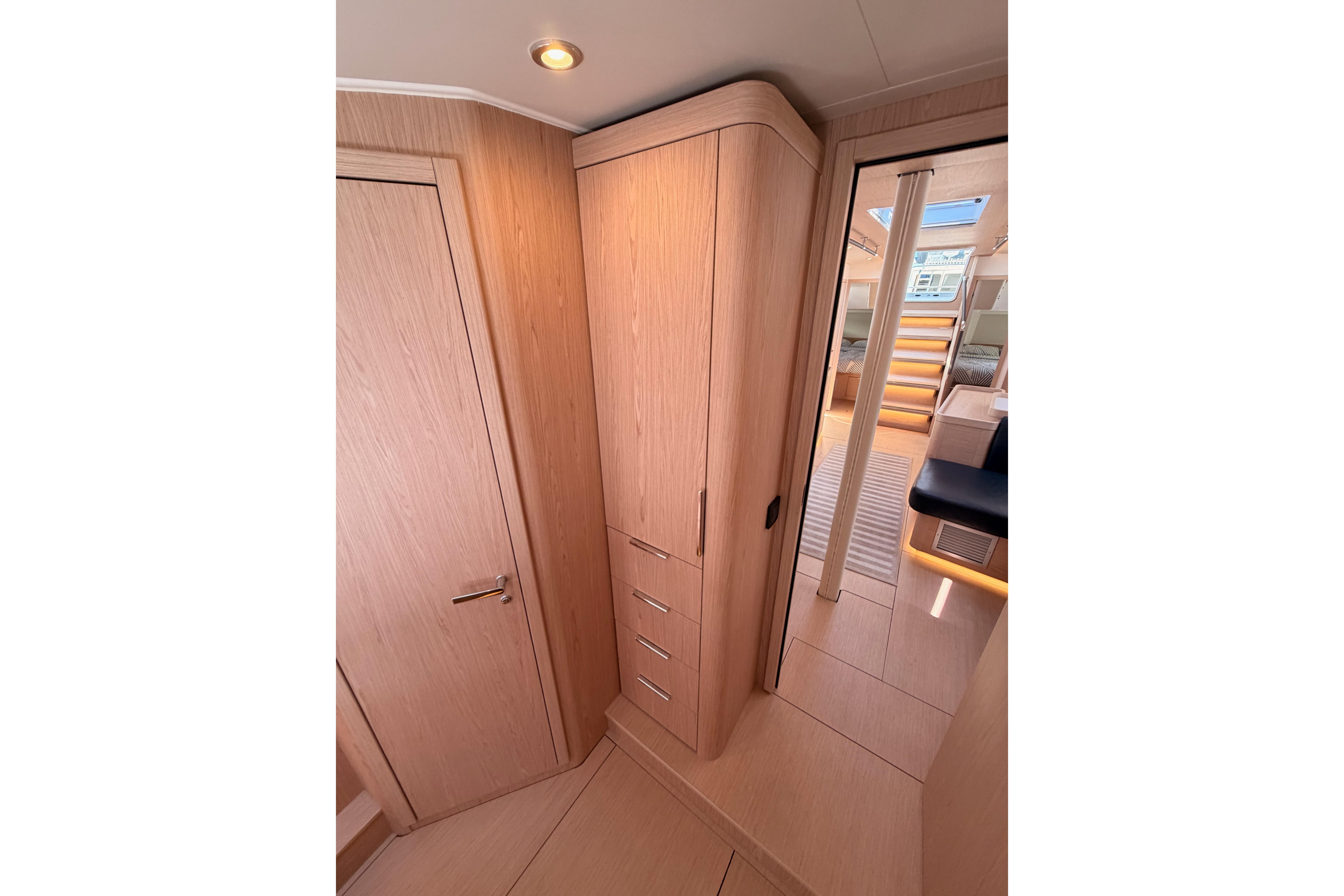 Interior of 2022 Beneteau Oceanis Yacht 54, featuring sleek wooden cabinetry and modern design.