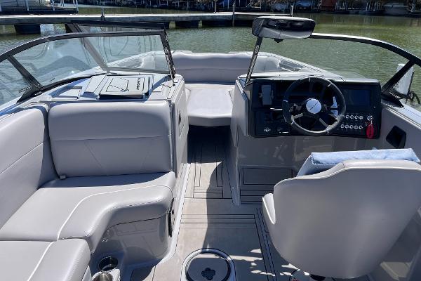 2024 Moomba Max boat interior with sleek seating and modern dashboard on a sunny day.