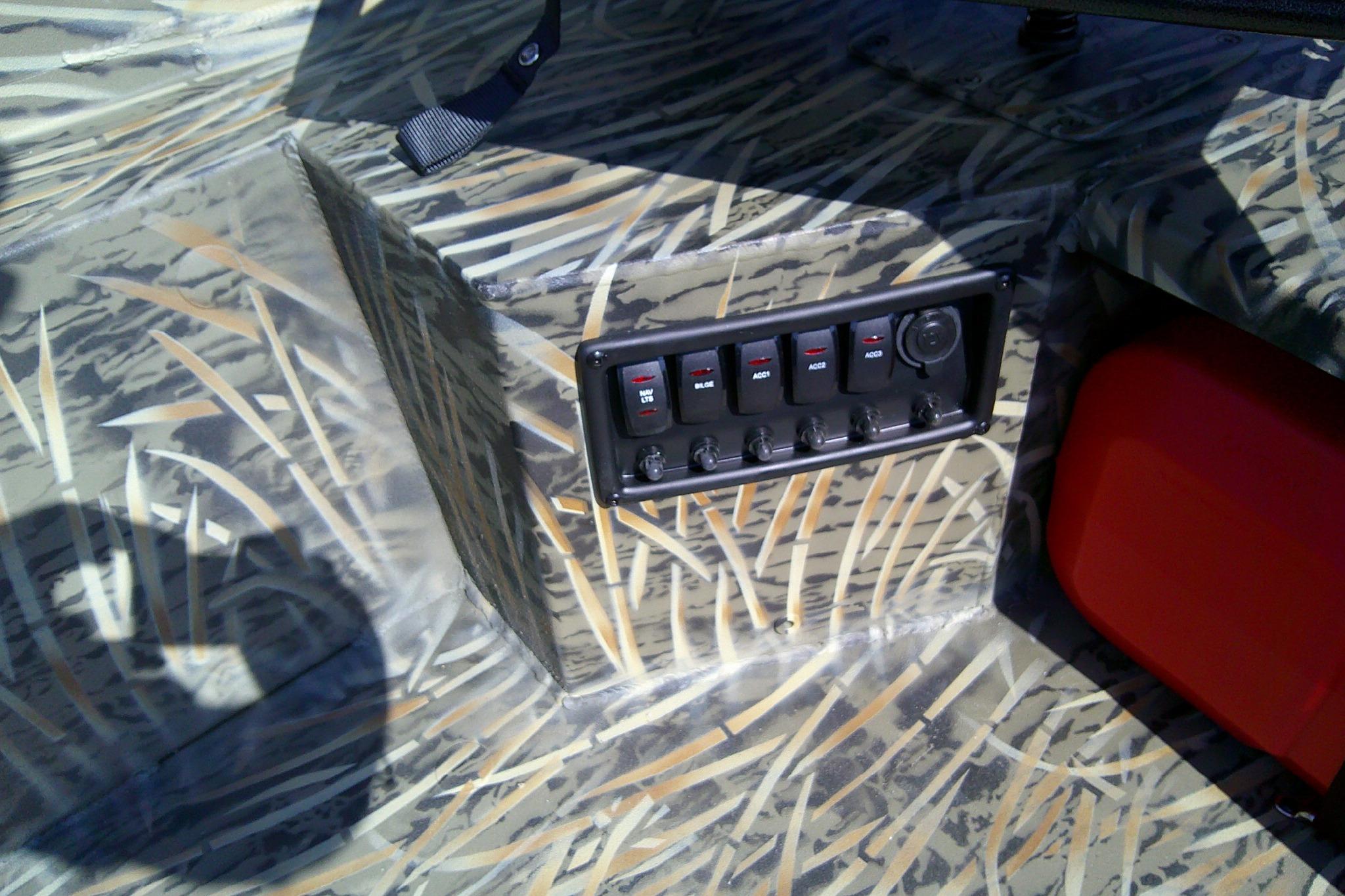 2026 Tracker Grizzly 1650 T Prairie Wings Edition boat interior with camo design and control panel.