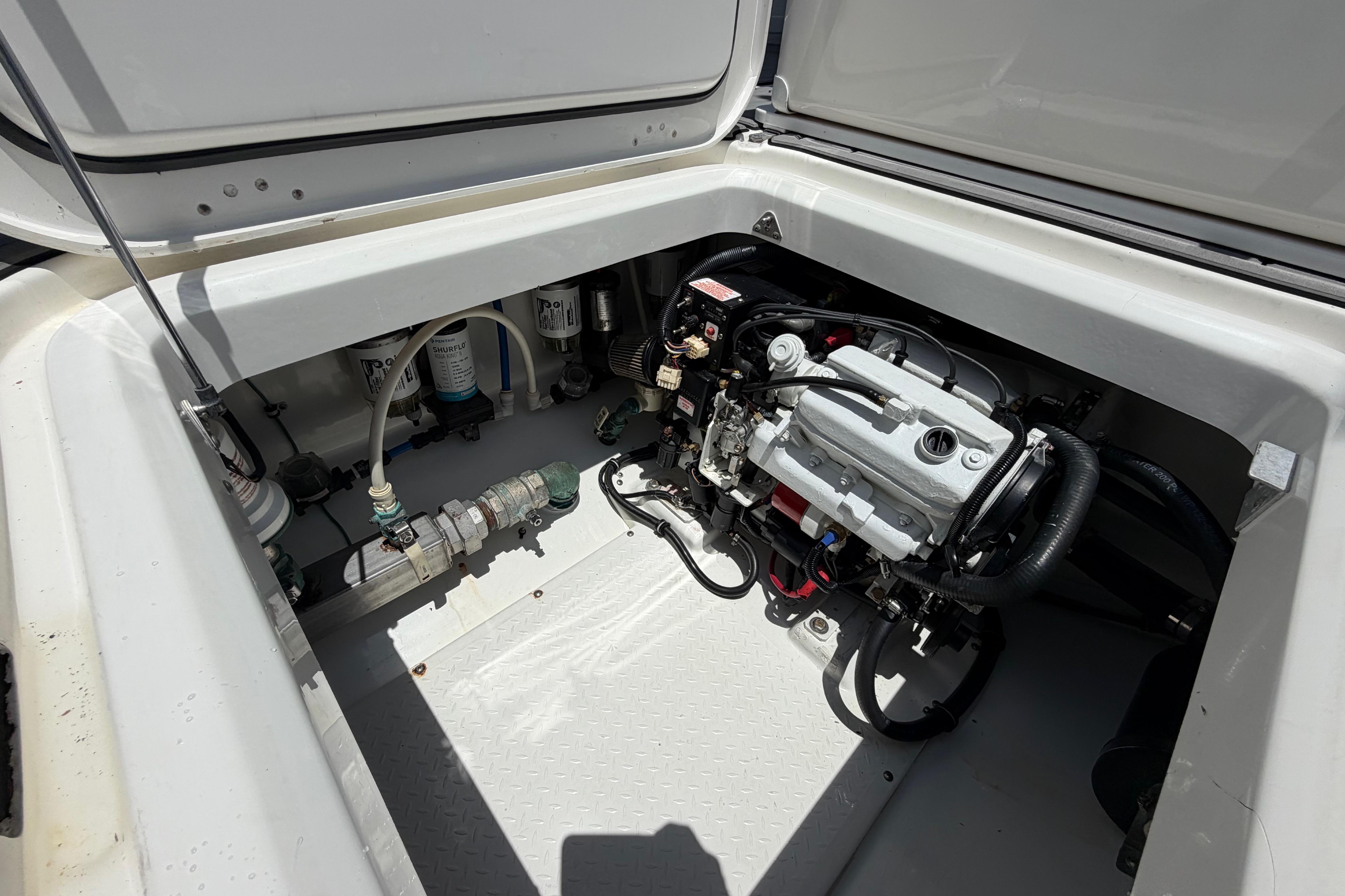 Engine compartment of a 2009 Everglades 350LX boat, showcasing mechanical components.