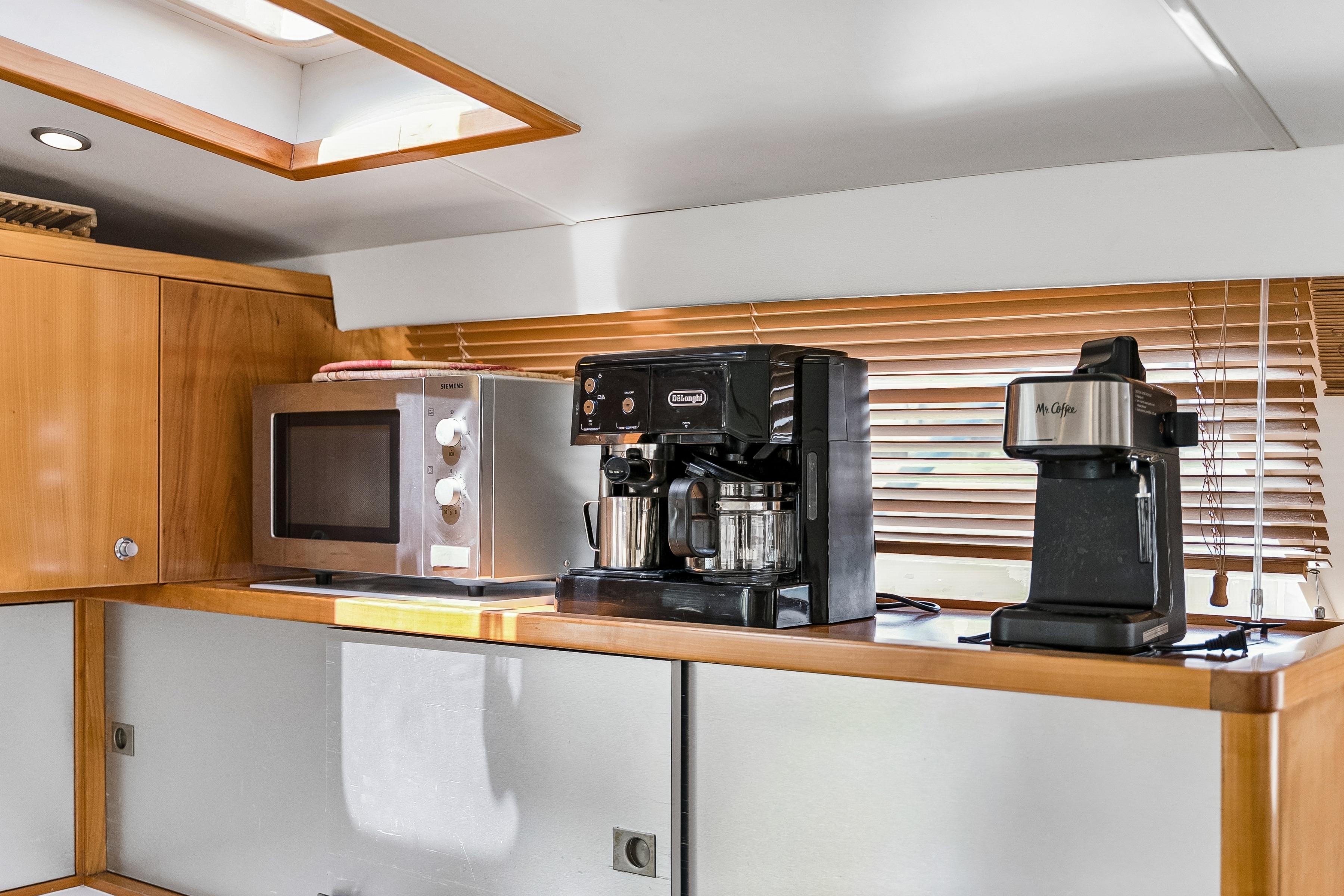 Galley of 2009 Catana 65 yacht with coffee makers and microwave.