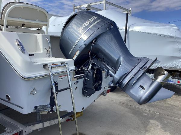 2022 Sailfish 220 CC boat with Yamaha outboard motor, docked on a trailer.