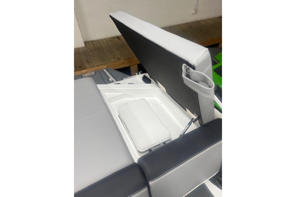 2025 Cobalt CS23 Surf boat seat with storage compartment open.