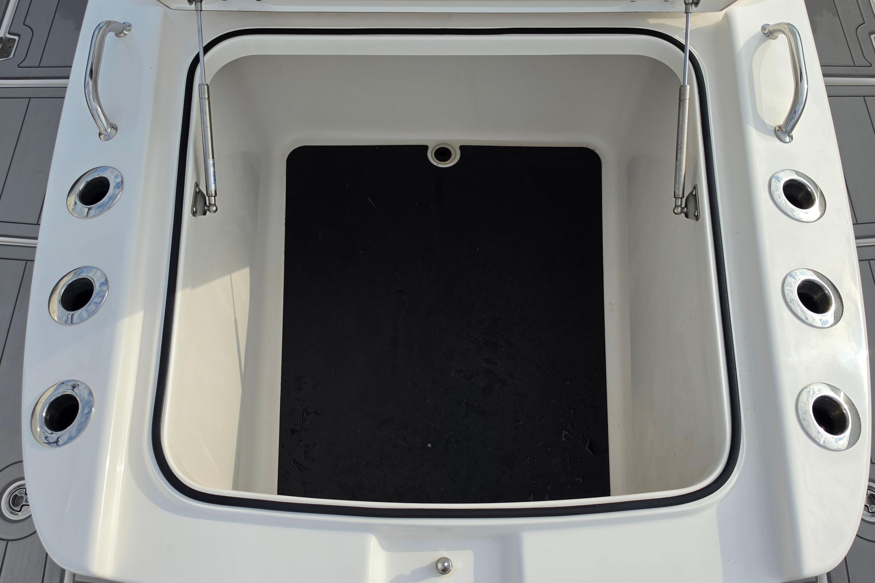 Open storage compartment on 2025 Caymas 34 CT boat deck.