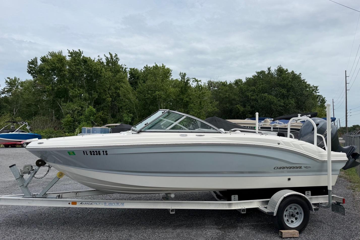2020 Chaparral 196 SSi boat on trailer, parked outdoors with trees in background.