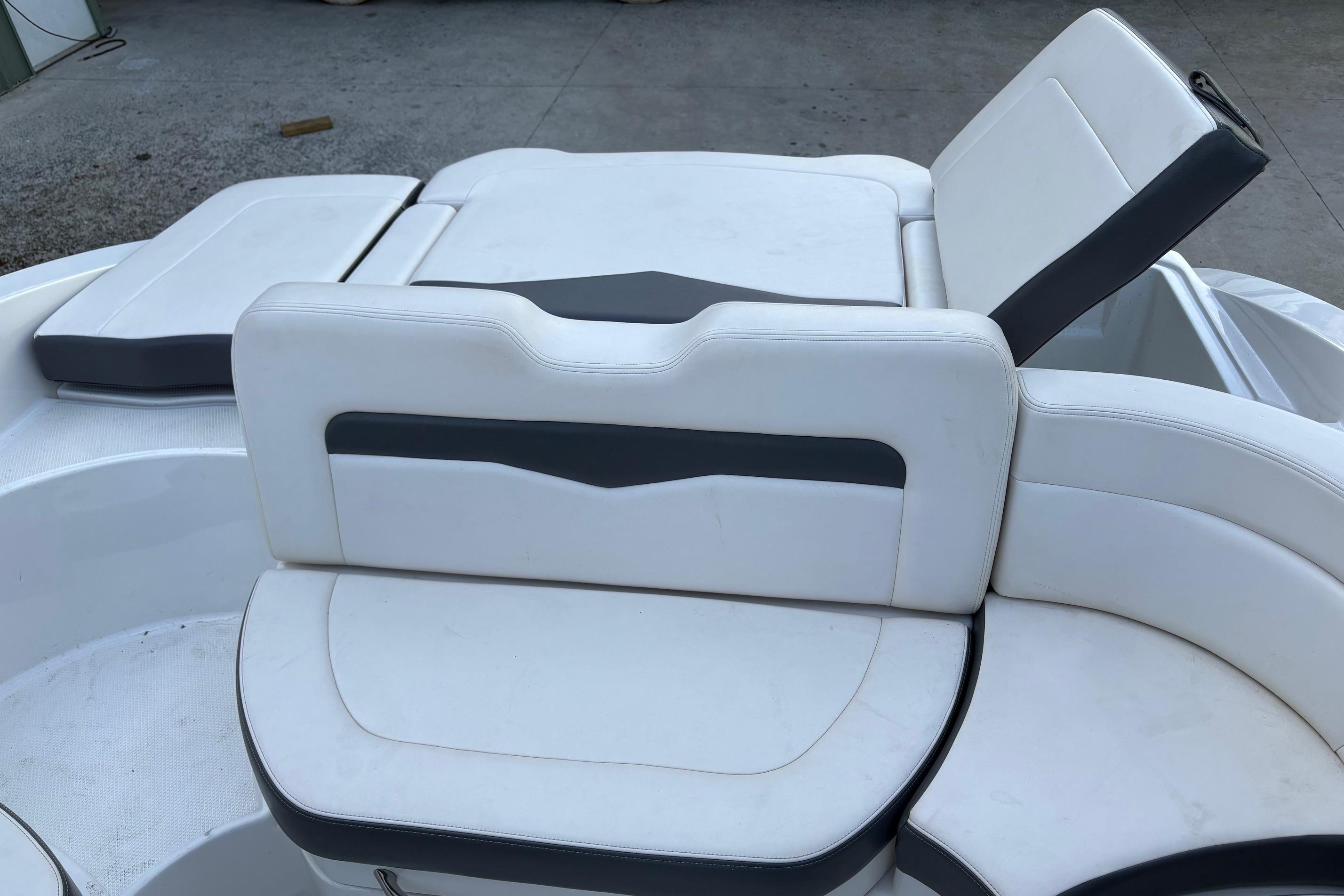 2016 Chaparral 246 SSi boat interior with white and gray seating arrangement.