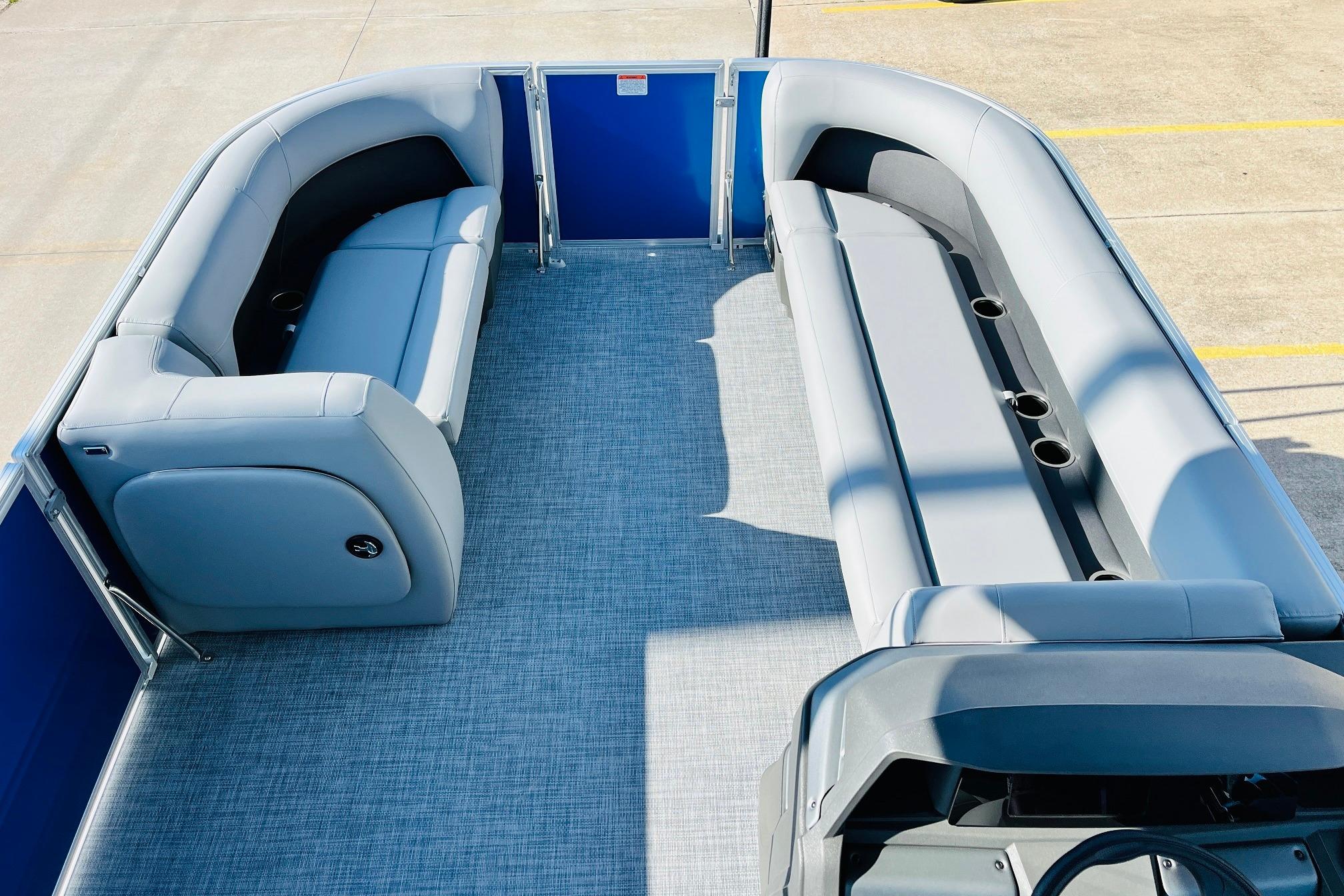 2026 Sun Tracker Party Barge 18 DLX interior with gray seating and blue accents.
