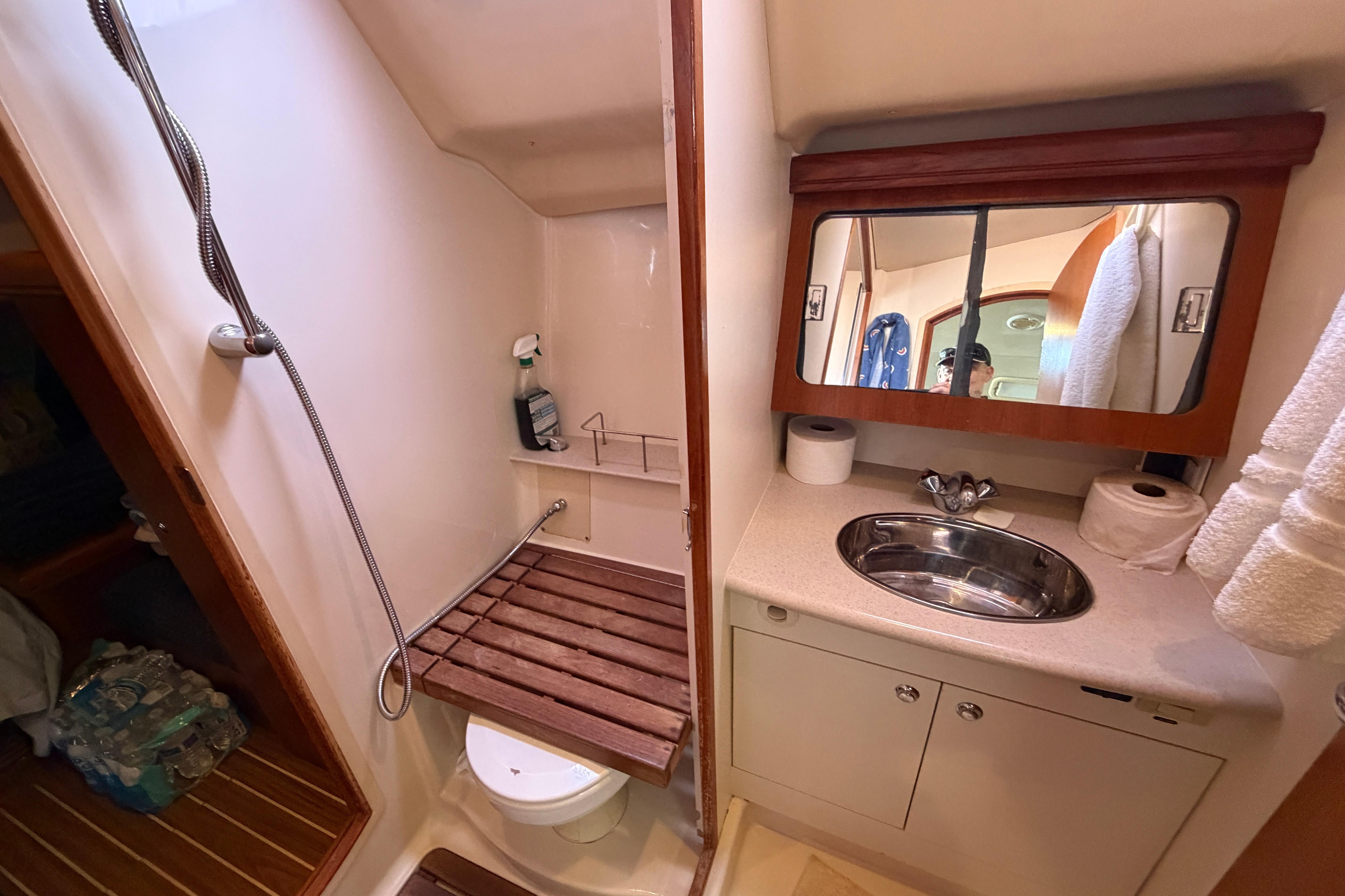 Bathroom interior of 2005 Hunter 38 yacht with shower and sink.