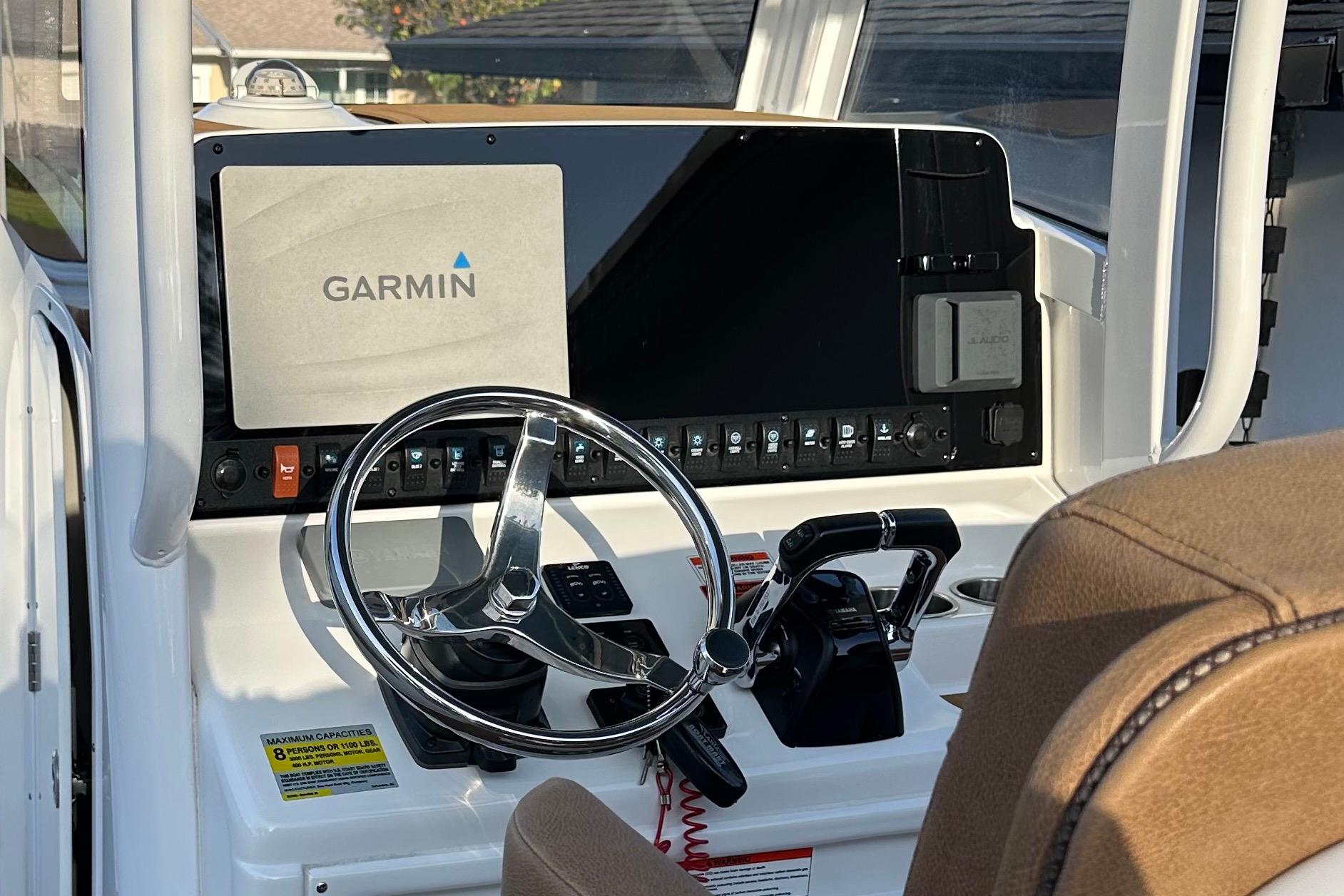 2019 Sea Hunt Gamefish 25 helm with Garmin navigation system and steering wheel.