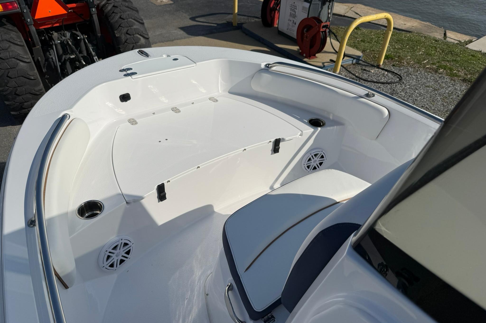 2026 Stingray 173 CC boat interior with seating and cup holders, docked near water.