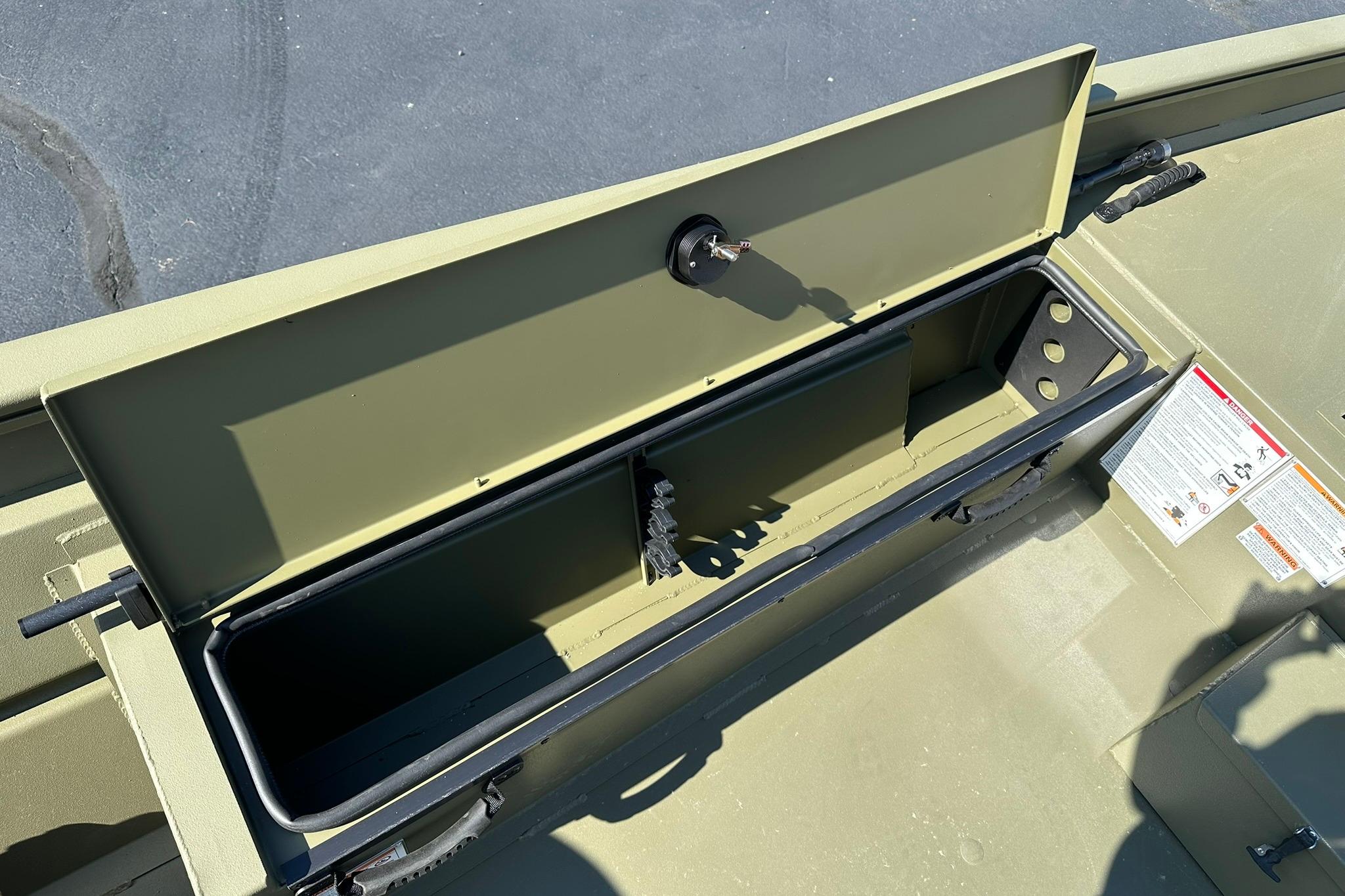 Open storage compartment in 2026 Lowe Roughneck 1860SC boat, showing interior details.