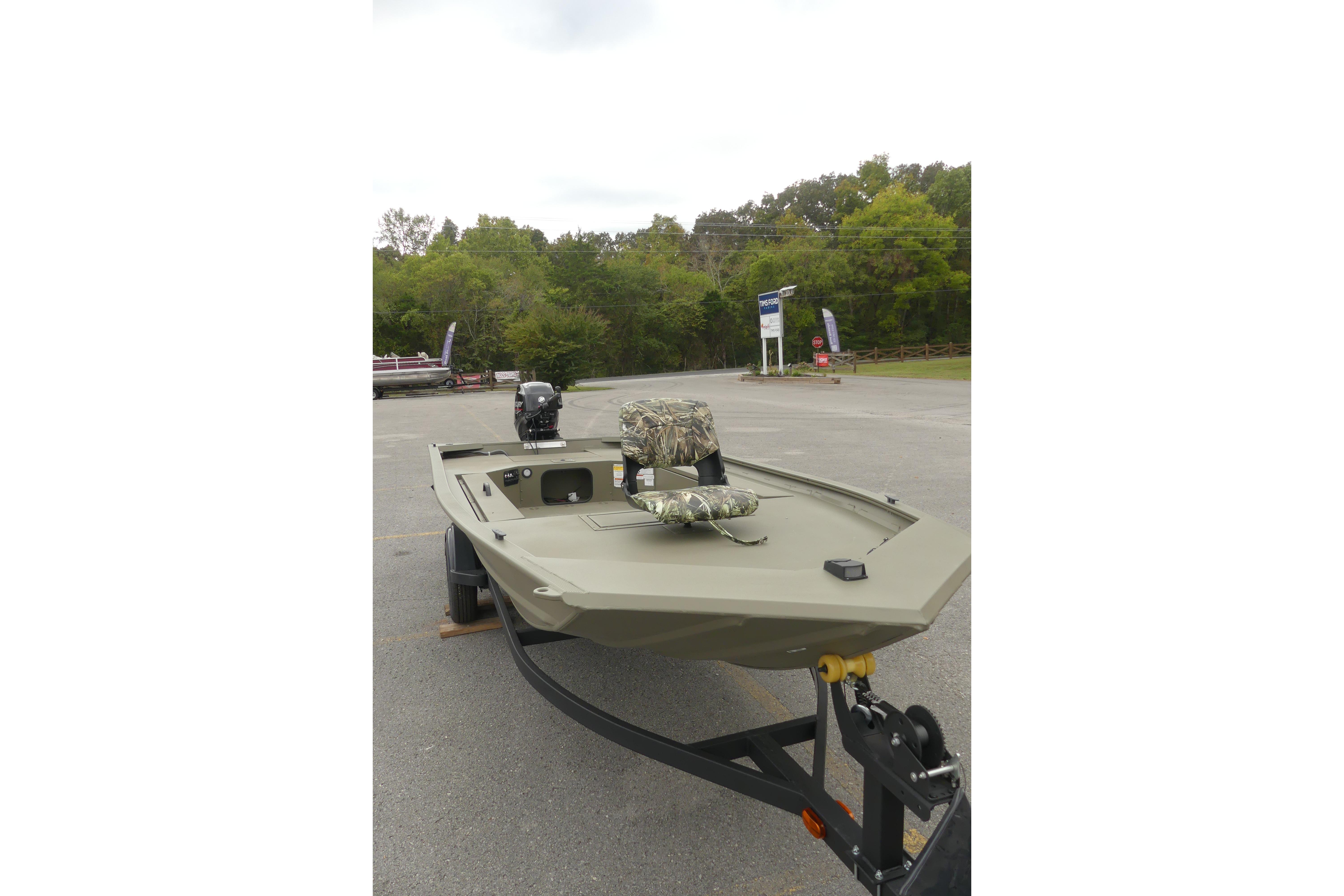 2025 Tracker Grizzly 1654 T Sportsman boat on trailer in outdoor setting.