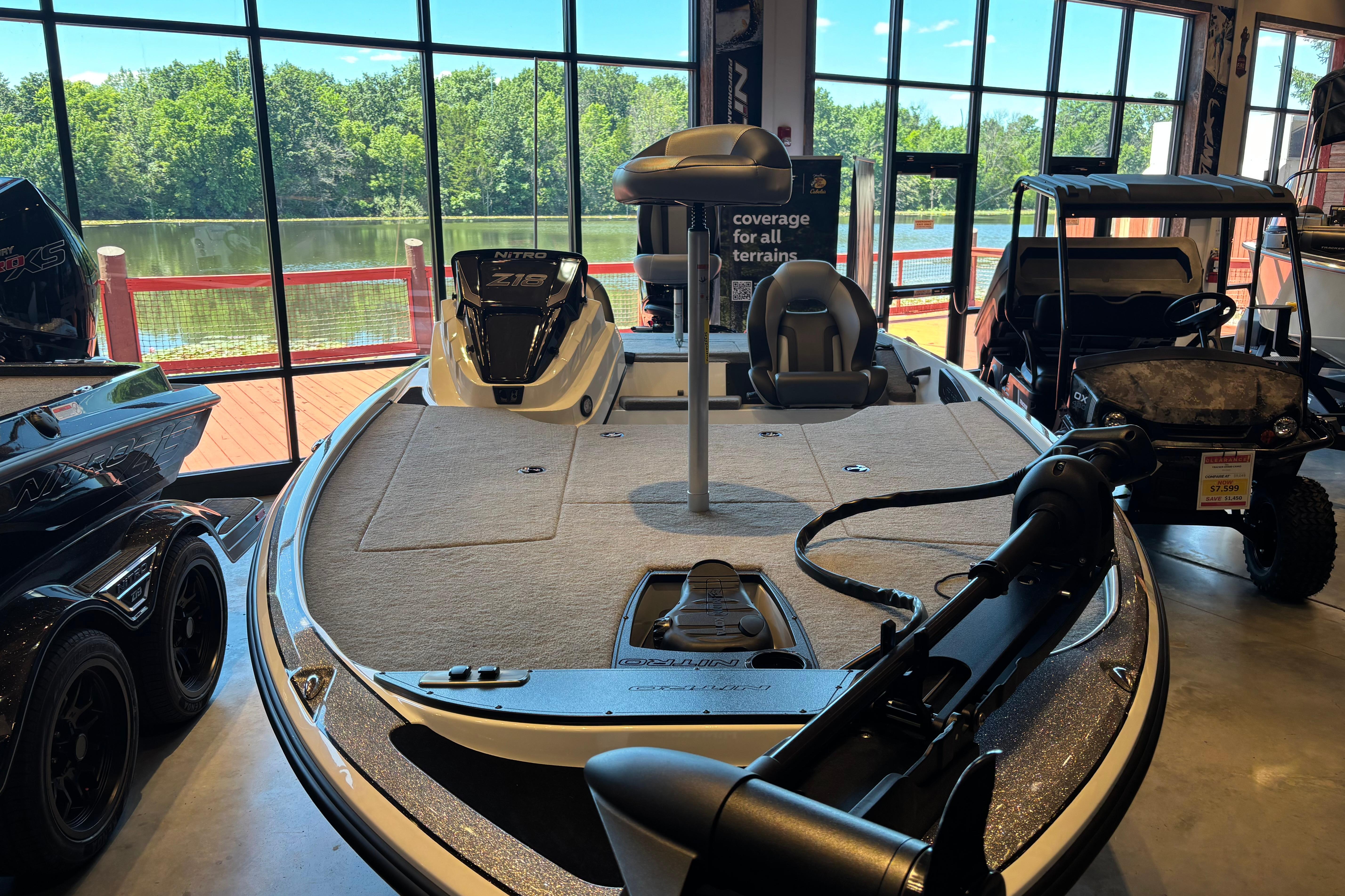 2025 Nitro Z18 boat displayed indoors with lake view through large windows.