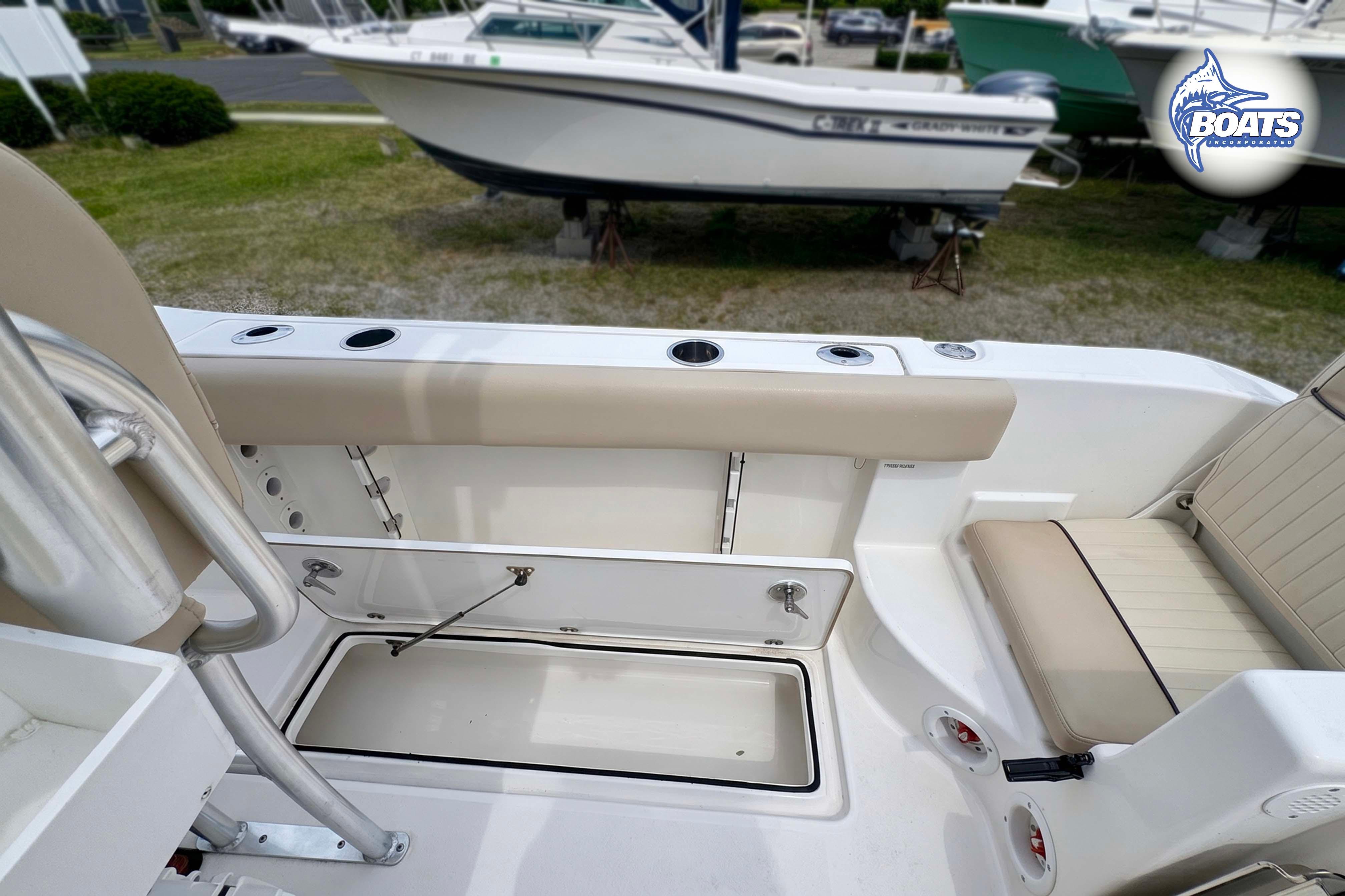 2015 Sea Fox 266 Commander boat interior with seating and storage compartments.
