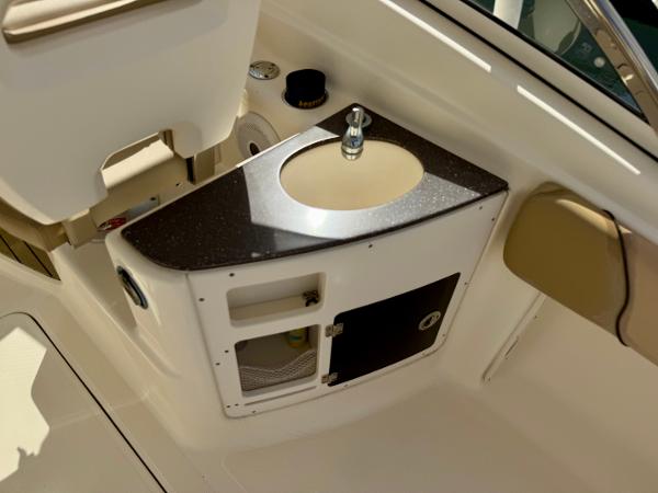2016 Scout 245 Dorado boat interior with sink and storage compartment.