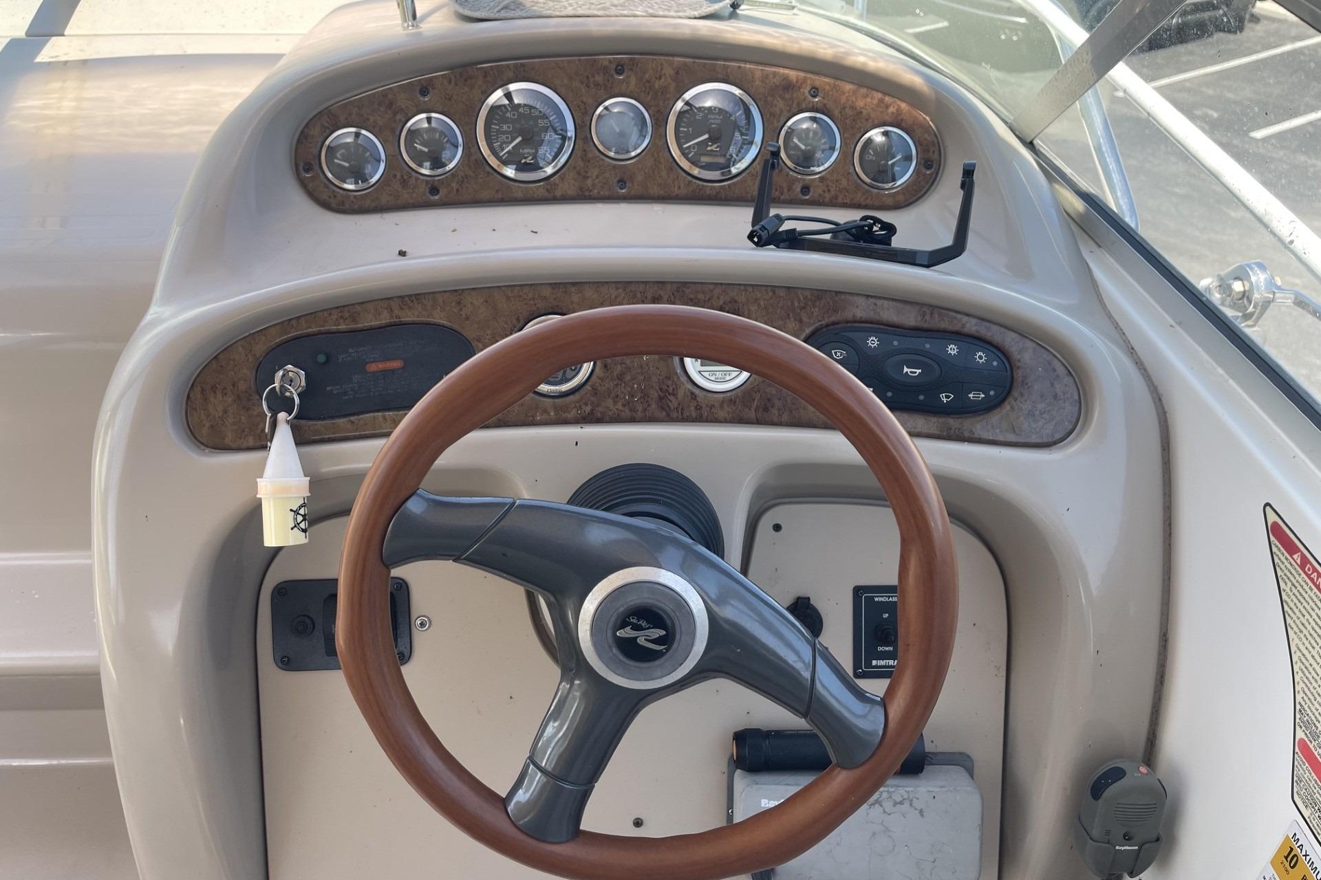 Steering wheel and dashboard of a 2000 Sea Ray Sundancer 260 boat.