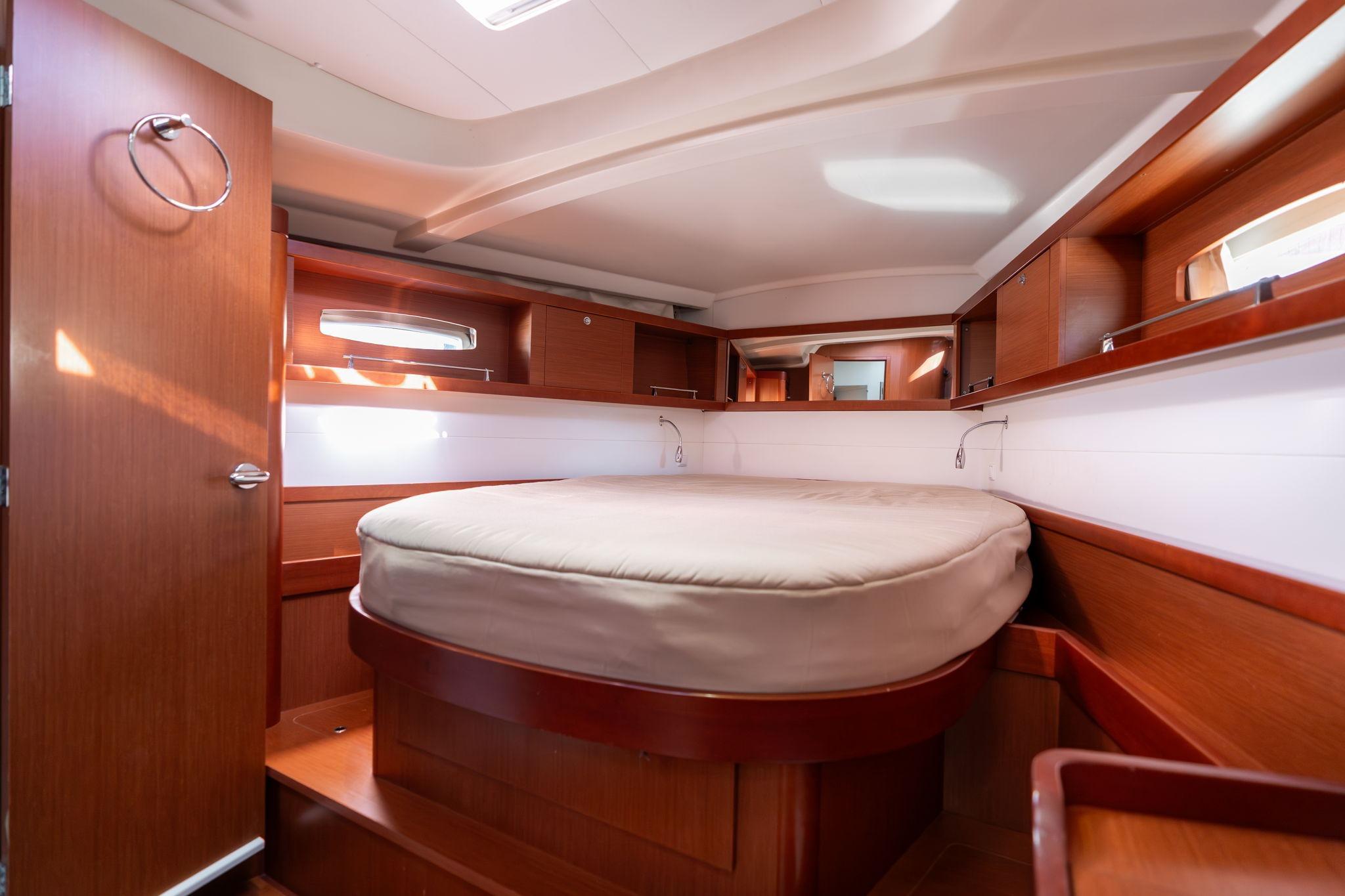 Luxurious cabin interior of 2013 Beneteau Oceanis 50 yacht with wooden finish.
