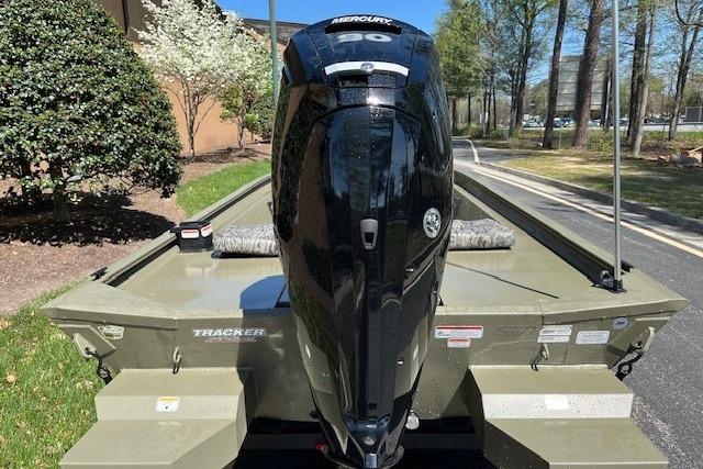 2026 Tracker Grizzly 1860 CC boat with Mercury engine, parked outdoors.