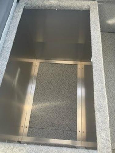 2025 Spartan 2600 Olympia storage compartment with carpeted interior and metal frame.