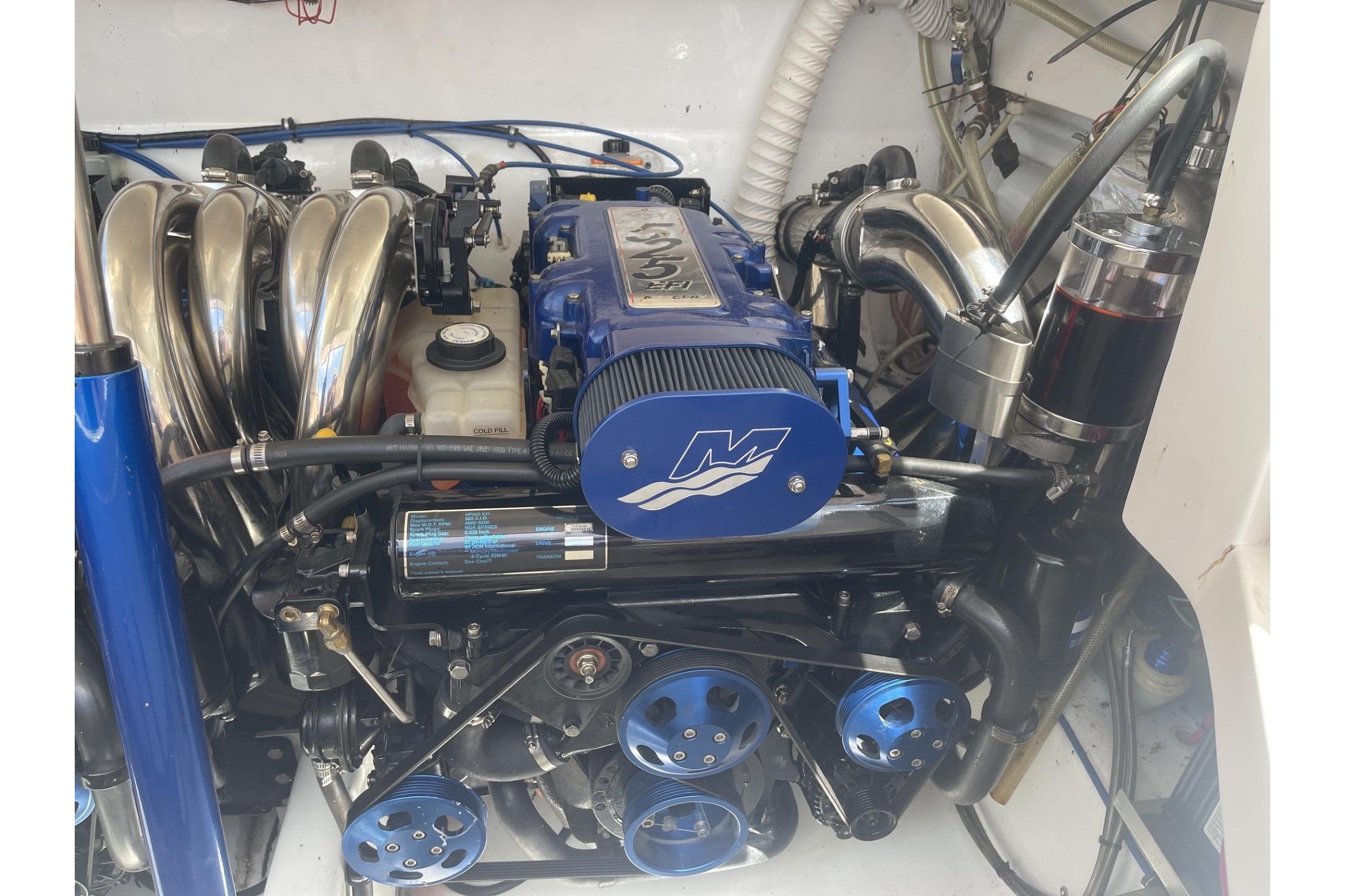 Engine of a 2006 Sonic 386 boat, featuring blue and chrome components.