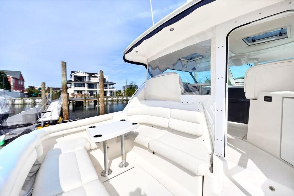 Luxurious 2006 Tiara Yachts 4300 Sovran with spacious white seating and waterfront view.