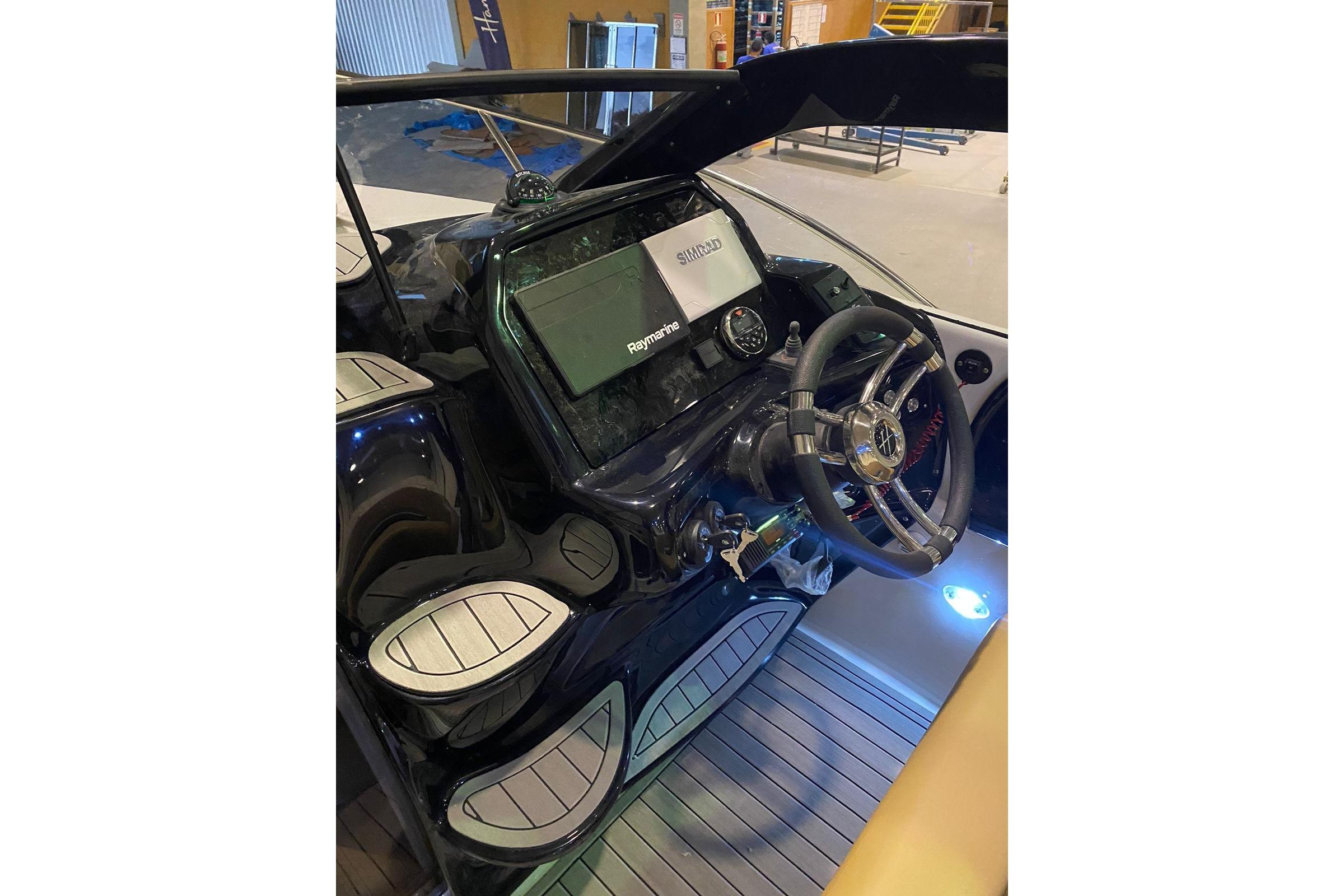 2024 Hanover 305 boat cockpit with modern steering and navigation system.