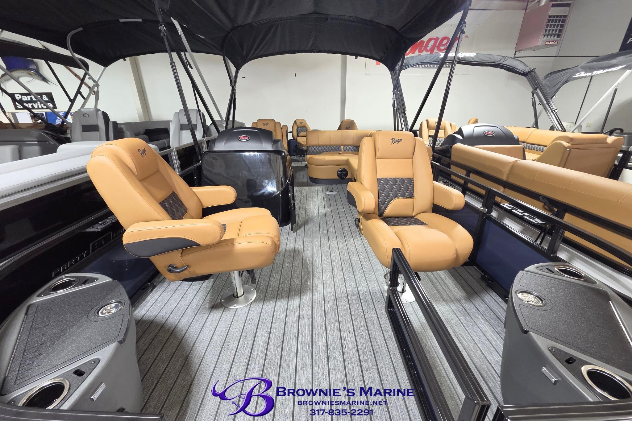 2026 Ranger 220F boat interior with tan seating, gray flooring, and canopy at Brownie's Marine.